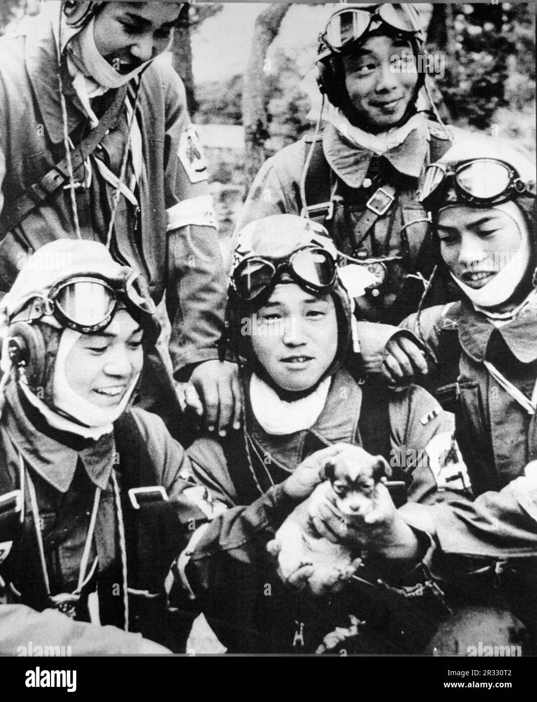Members of 72nd Shinbu Squadron. Three of the five are 17 years old and the other two are 18 and 19 years old. The photo was taken the day before their mission. Left to right: front row Tsutomu Hayakawa, Yukio Araki, Takamasa Senda back row Kaname Takahashi, Mitsuyoshi Takahashi. Each of these young men were corporals. At 17, Yukio Araki (holding the dog) is the youngest known Kamikaze pilot to die in the war. Stock Photo