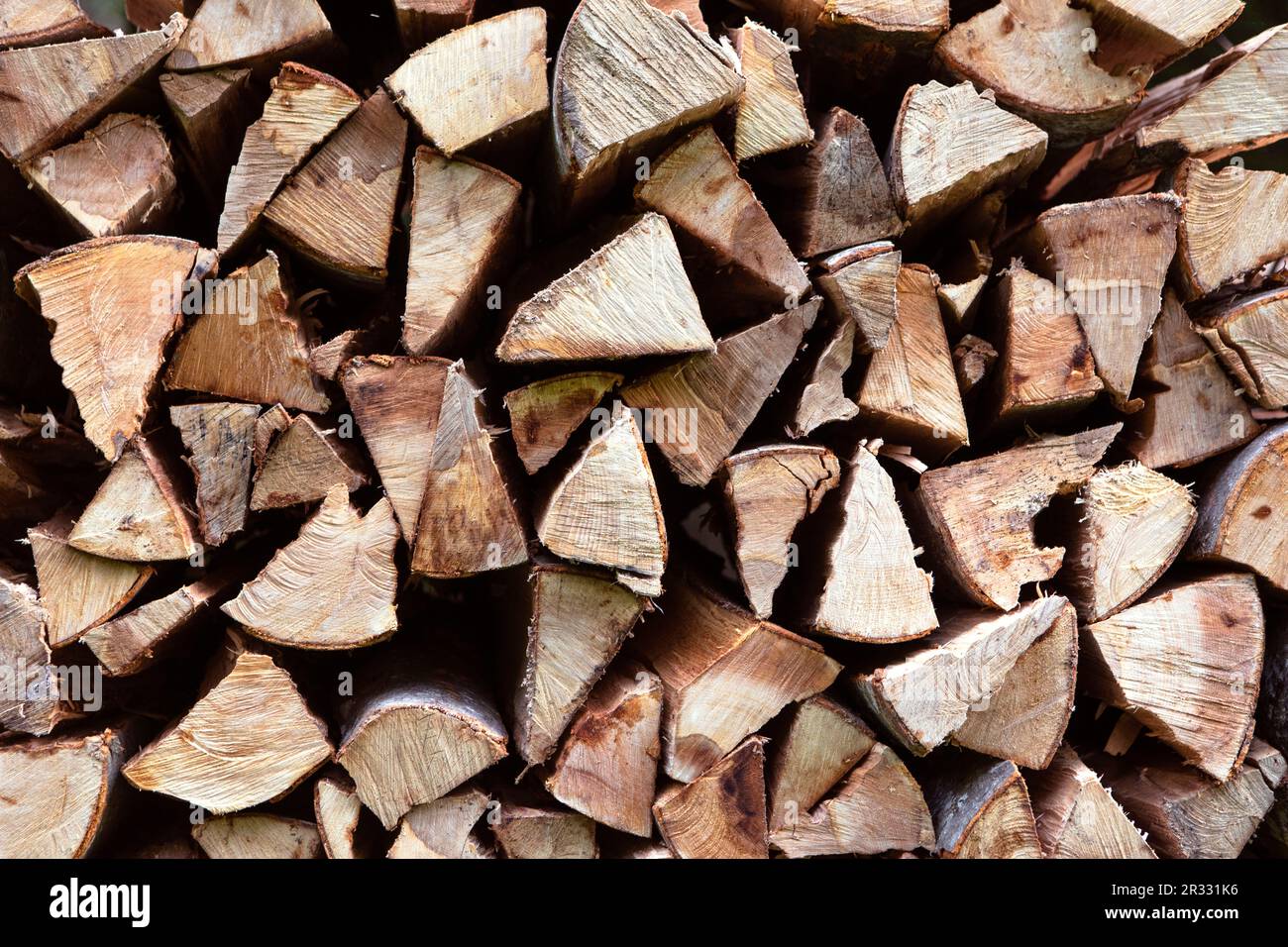 Texture of chopped wood. Wood for burning in the stove or fireplace. Pile of wood pieces background. Stock Photo