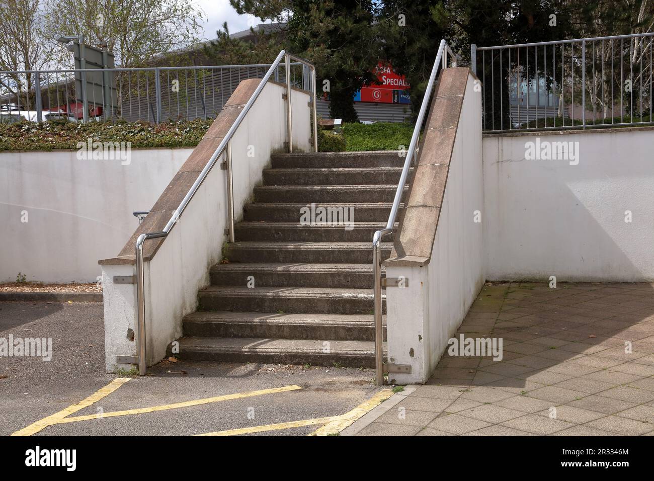 A set of Concrete steps allowing access between stores in the industrial area of Bridgend across a very busy roadway. Stock Photo