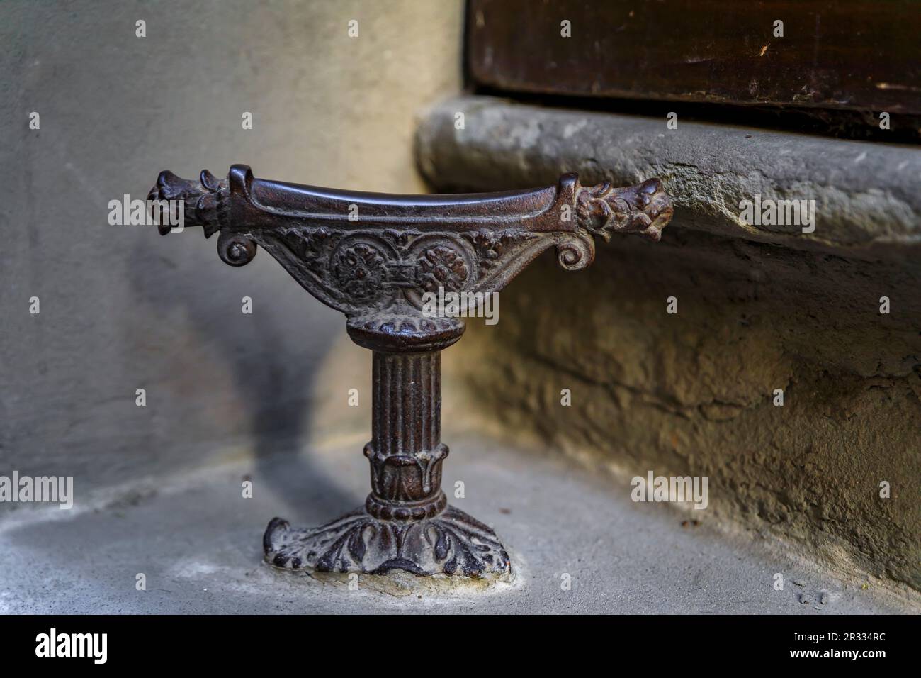 Ornate medieval metail boot scraper on a street in Oltrarno Santo Spirito area of Centro Storico or Historic Centre of Florence, Italy Stock Photo