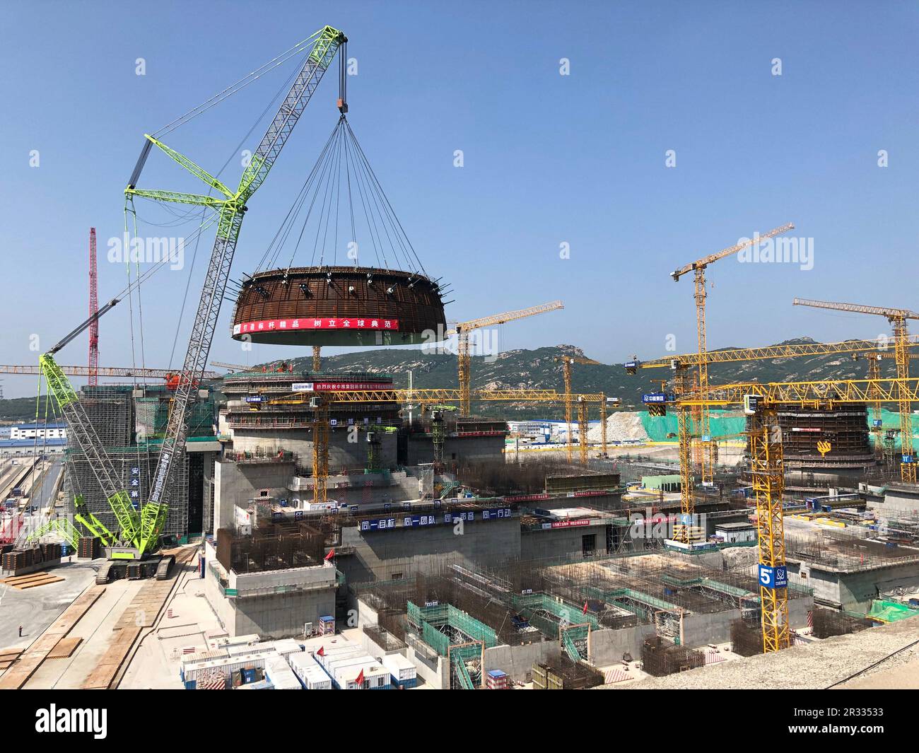(230522) -- LIANYUNGANG, May 22, 2023 (Xinhua) -- This photo taken on May 19, 2023 shows a crawler crane lifting the circular belt of the reactor dome of the Tianwan nuclear power plant Unit 7 in east China's Jiangsu Province. TO GO WITH 'Across China: Tianwan nuclear power plant installs key component of Unit 7' (China National Nuclear Corporation/Handout via Xinhua) Stock Photo