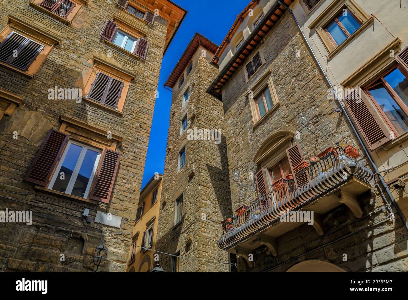 Medieval Renaissance gothic tower buildings along a narrow street in Centro Storico or Historic Centre of Florence, Italy Stock Photo