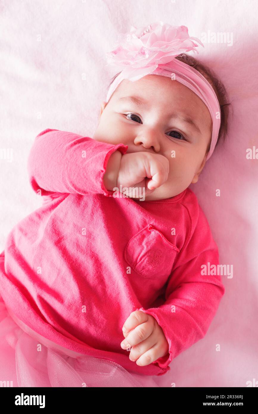 Baby in pink dress Stock Photo - Alamy