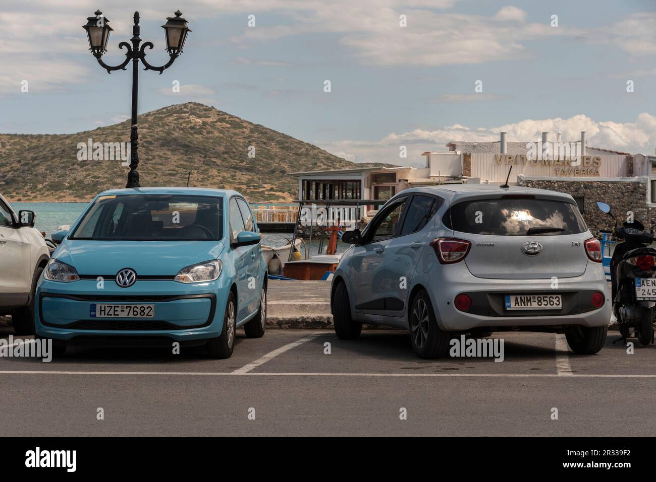 Elounda, Crete, Greece, EU. 2023. Parked vehicles well and badly parking positions Stock Photo