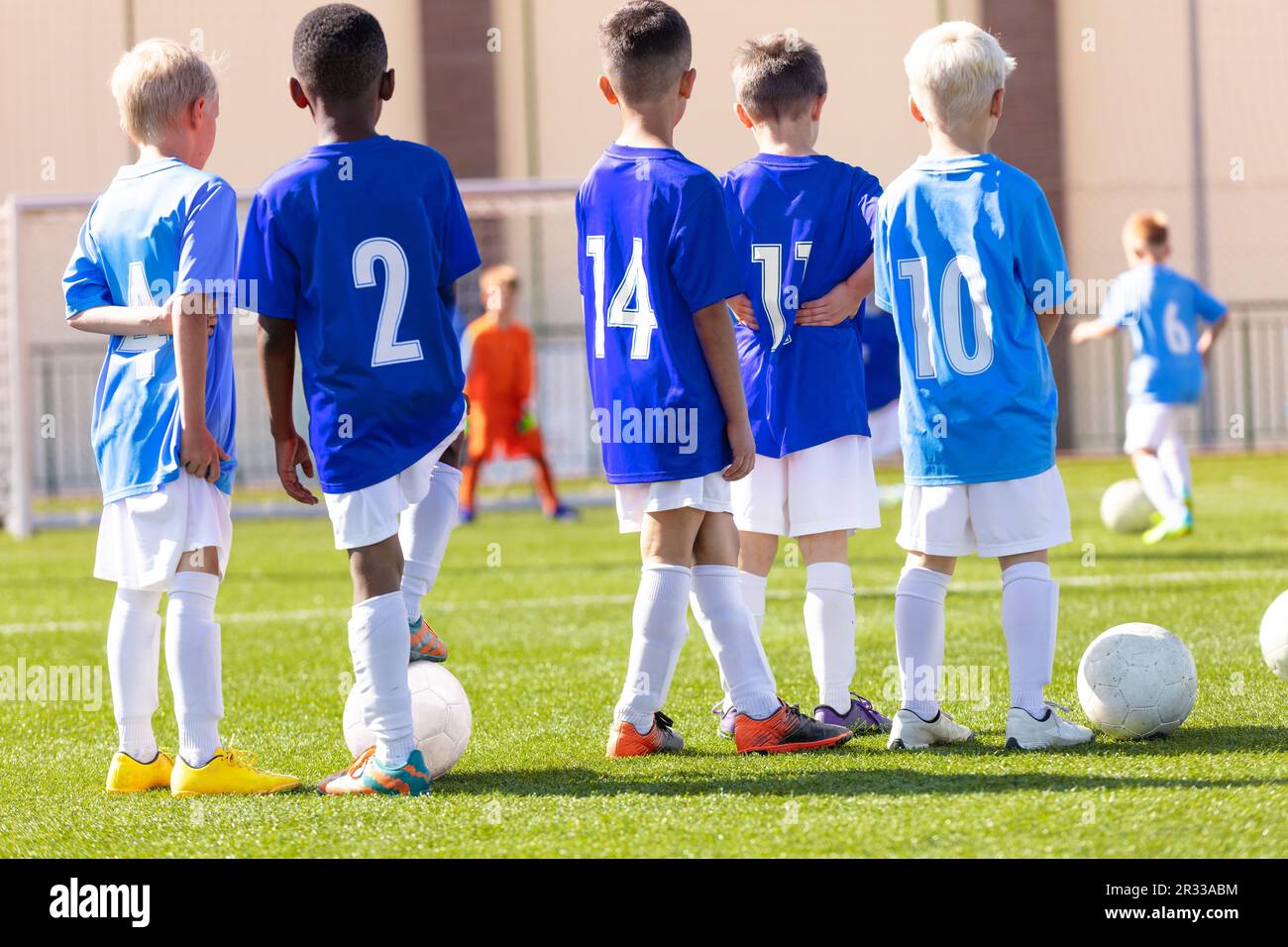 Youth soccer football team. Soccer team practicing penalty kick. Group photo. Soccer players standing together at training. Teammates at soccer traini Stock Photo