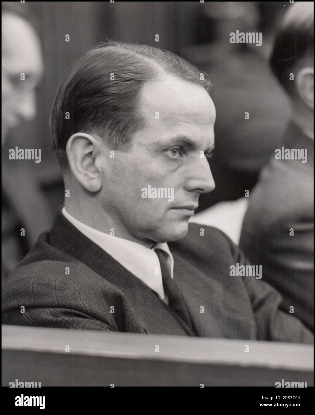 Defendant Otto Ohlendorf testifies on his own behalf at the Einsatzgruppen Trial. Otto Ohlendorf was a German SS functionary and Holocaust perpetrator during the Nazi era. An economist by education, he was head of the Sicherheitsdienst Inland, responsible for intelligence and security within Germany.  Born: 4 February 1907, Hoheneggelsen, Söhlde, Germany Died: 7 June 1951, Landsberg Prison, Landsberg am Lech, Germany Nationality: German Party: Nazi Party Education: Leipzig University Conviction(s): Crimes against humanity; War crimes; Membership in a criminal organization penalty: Death Stock Photo