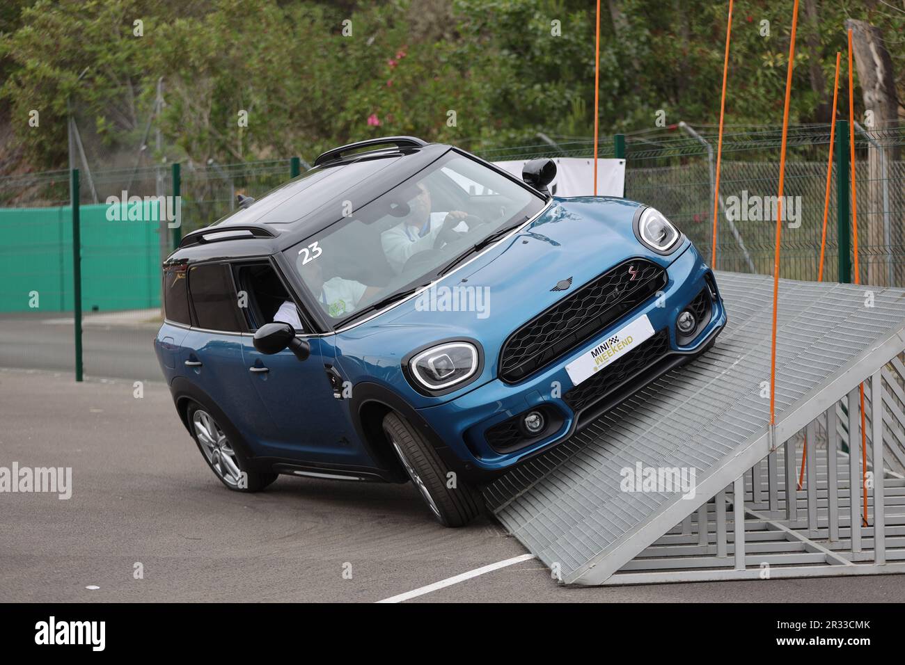 Mini Cooper S being test driven by customers up a ramp at the Mini driving experience at Circuit of Catalonia in Montmelo, Spain Stock Photo