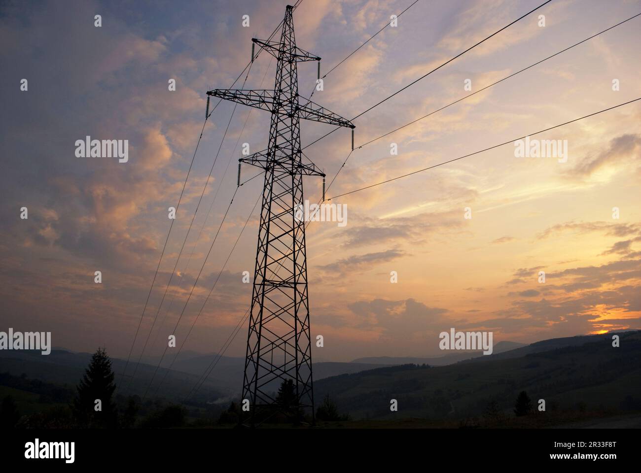Sunset in mountains and electrified track Stock Photo