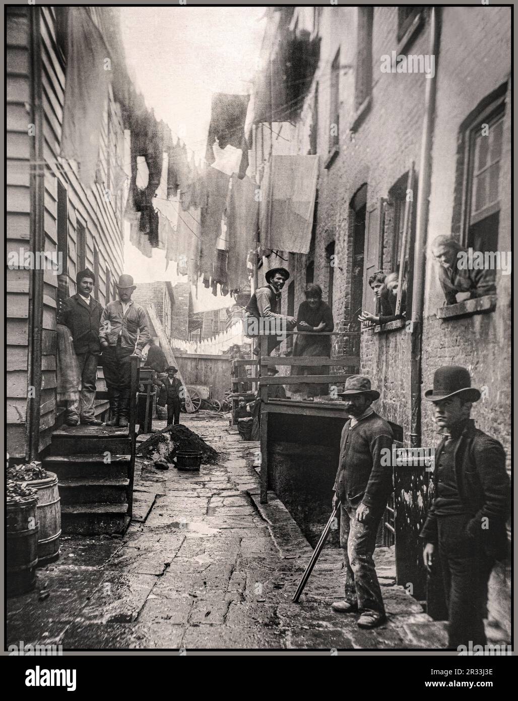 Bandits' Roost, 59 Mulberry Street. Gelatin silver print, Jacob August Riis Date 1888 New York crime neighbourhood with men posing in their lawless run down home street New York America USA Stock Photo