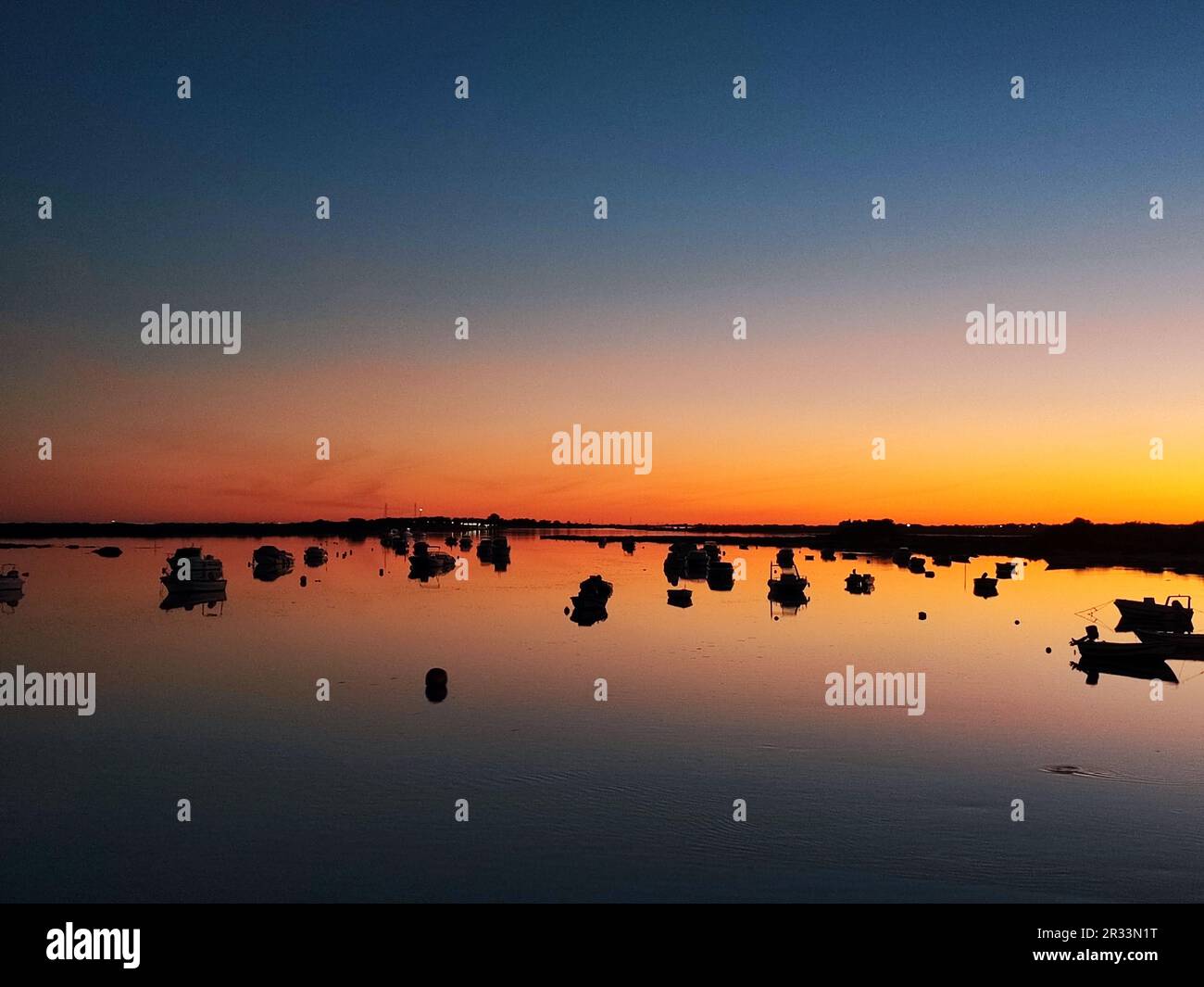 Sunset sky in river with boats Stock Photo - Alamy