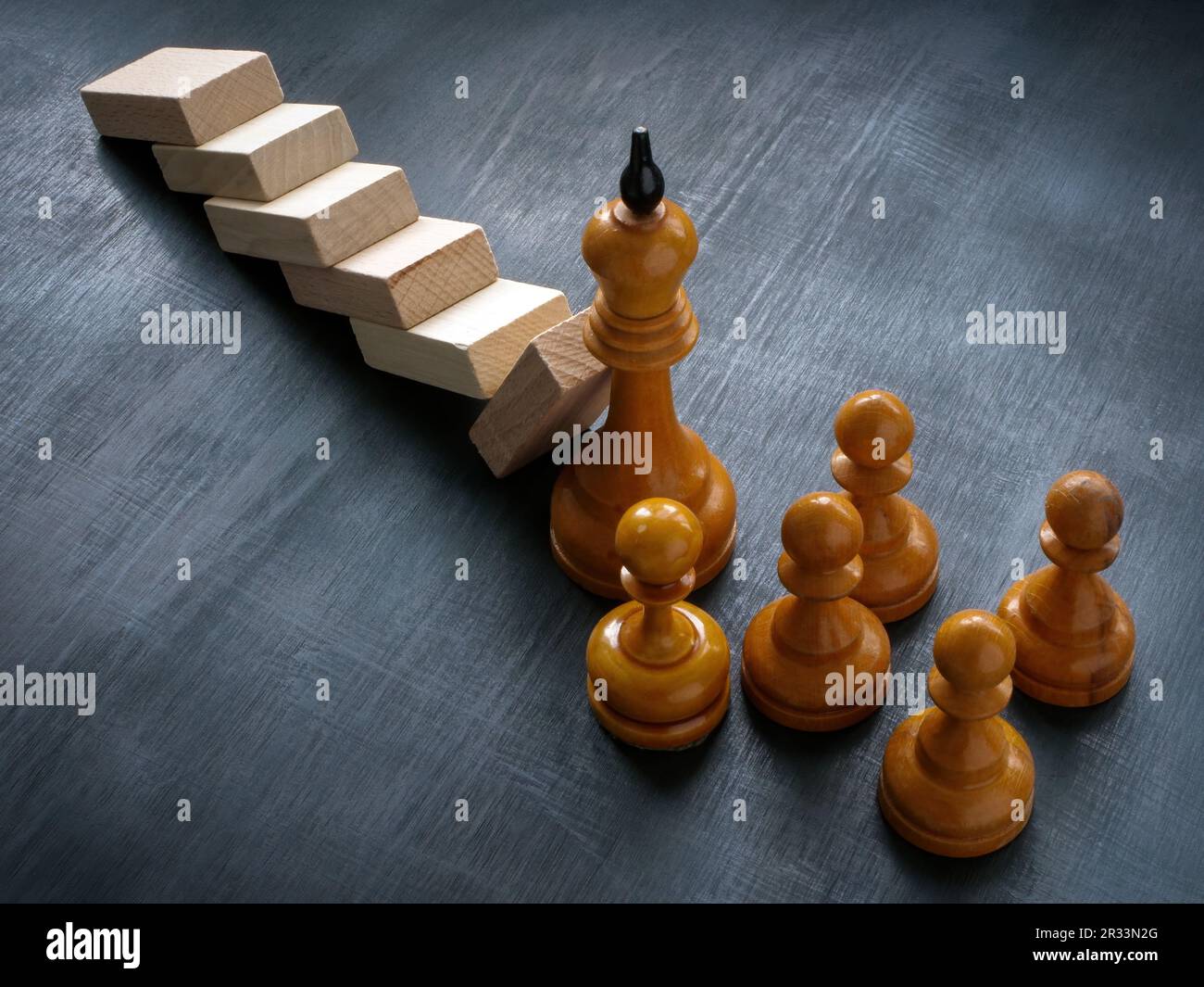 The chess king holds the fallen blocks as a symbol of leadership and crisis management. Stock Photo