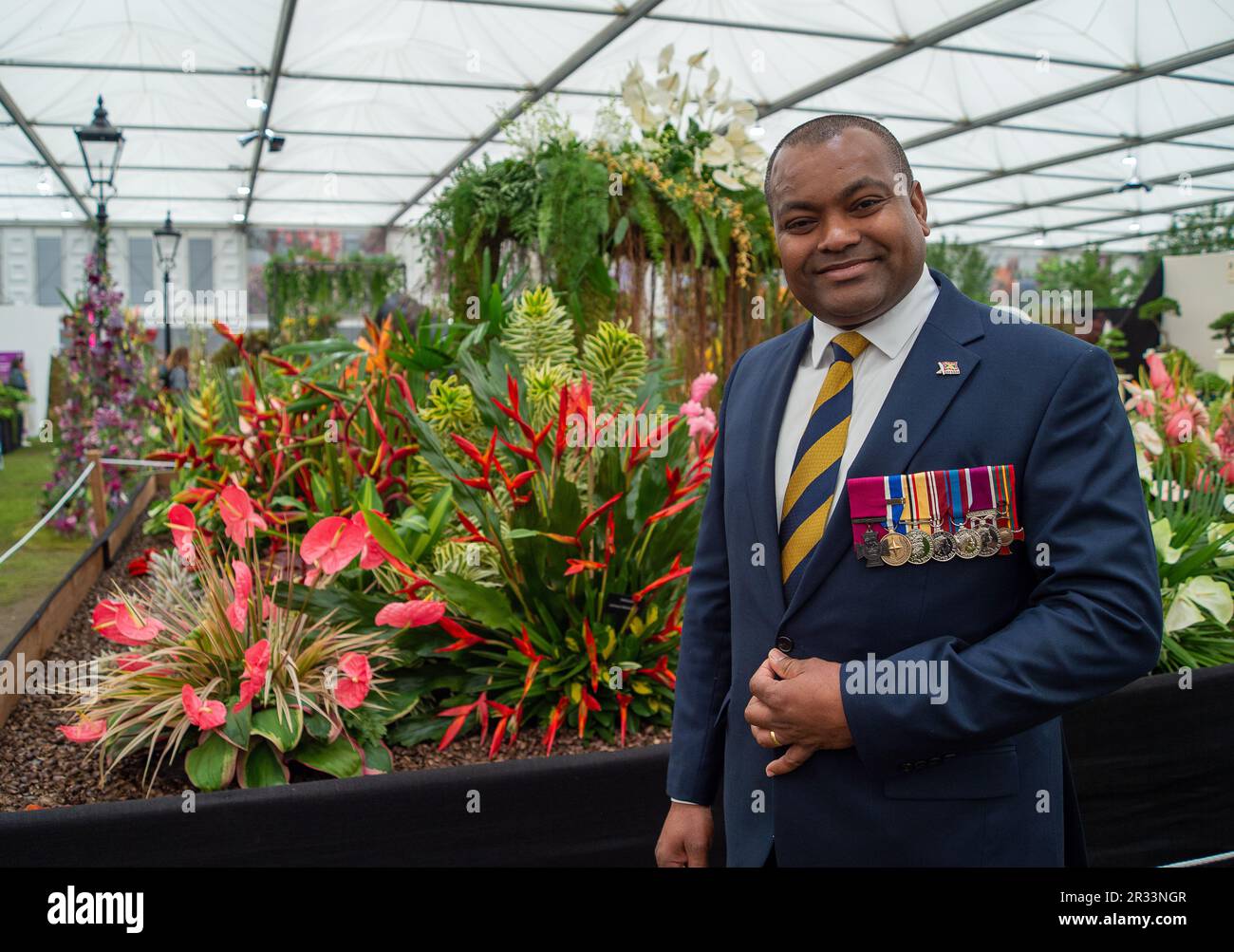 Chelsea, London, UK. 22nd May, 2023. Victoria Cross holder, Johnson Beharry, VC, COG at the RHS Chelsea Flower Show at the Grenadian Flower Stand. Credit: Maureen McLean/Alamy Live News Stock Photo