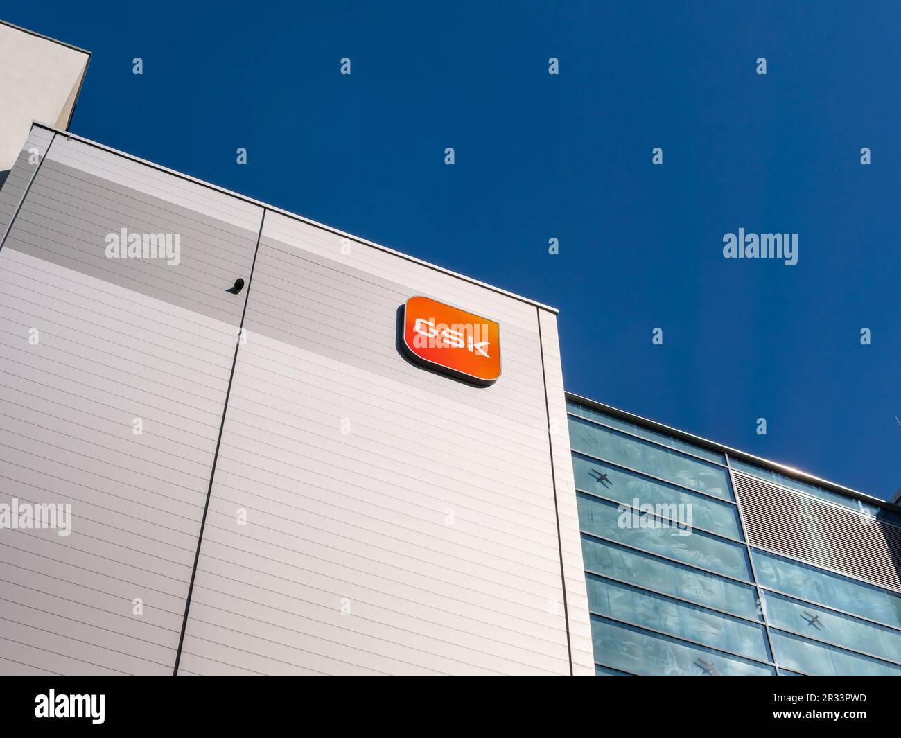 GSK logo sign of the multinational pharmaceutical company on a production hall. Big player in the health care industry and popular employer in Saxony. Stock Photo