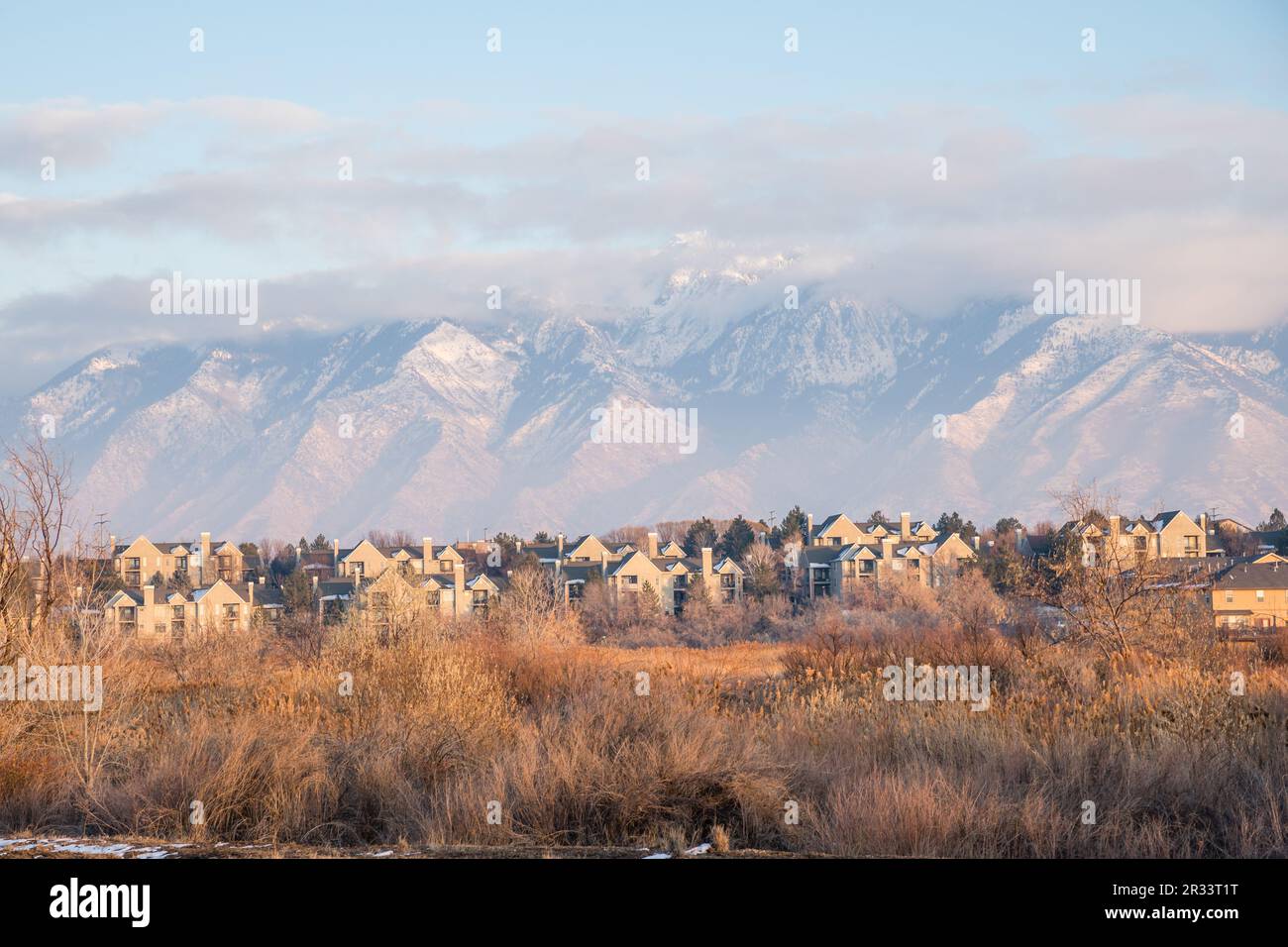 Neighborhood of new homes with snow covered mountains in background. Stock Photo