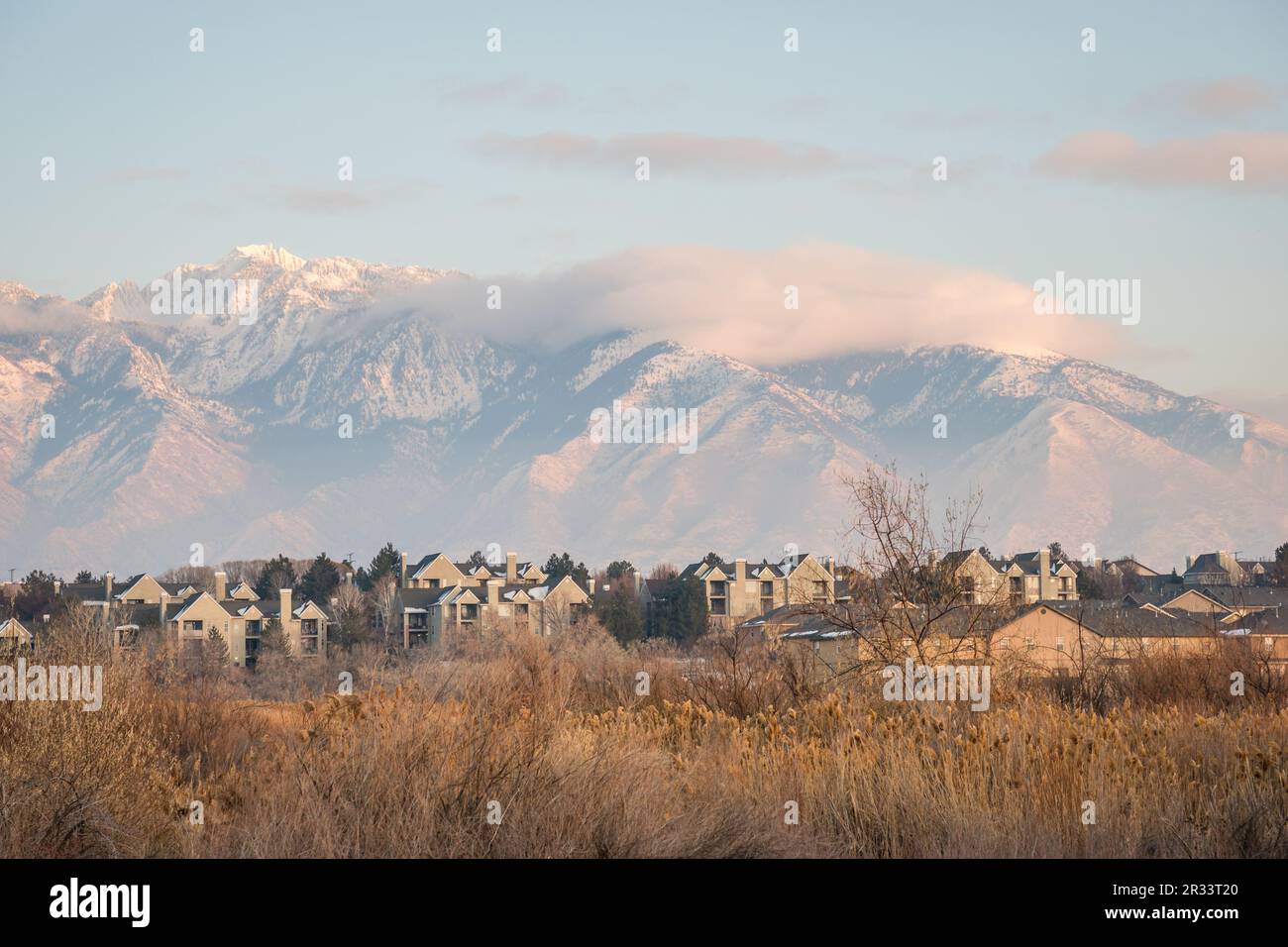 Neighborhood of new homes with snow covered mountains in background. Stock Photo