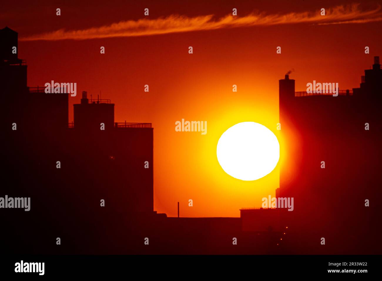 View of the sunset over Lower Manhattan from a window in Williamsburg, Brooklyn. Stock Photo