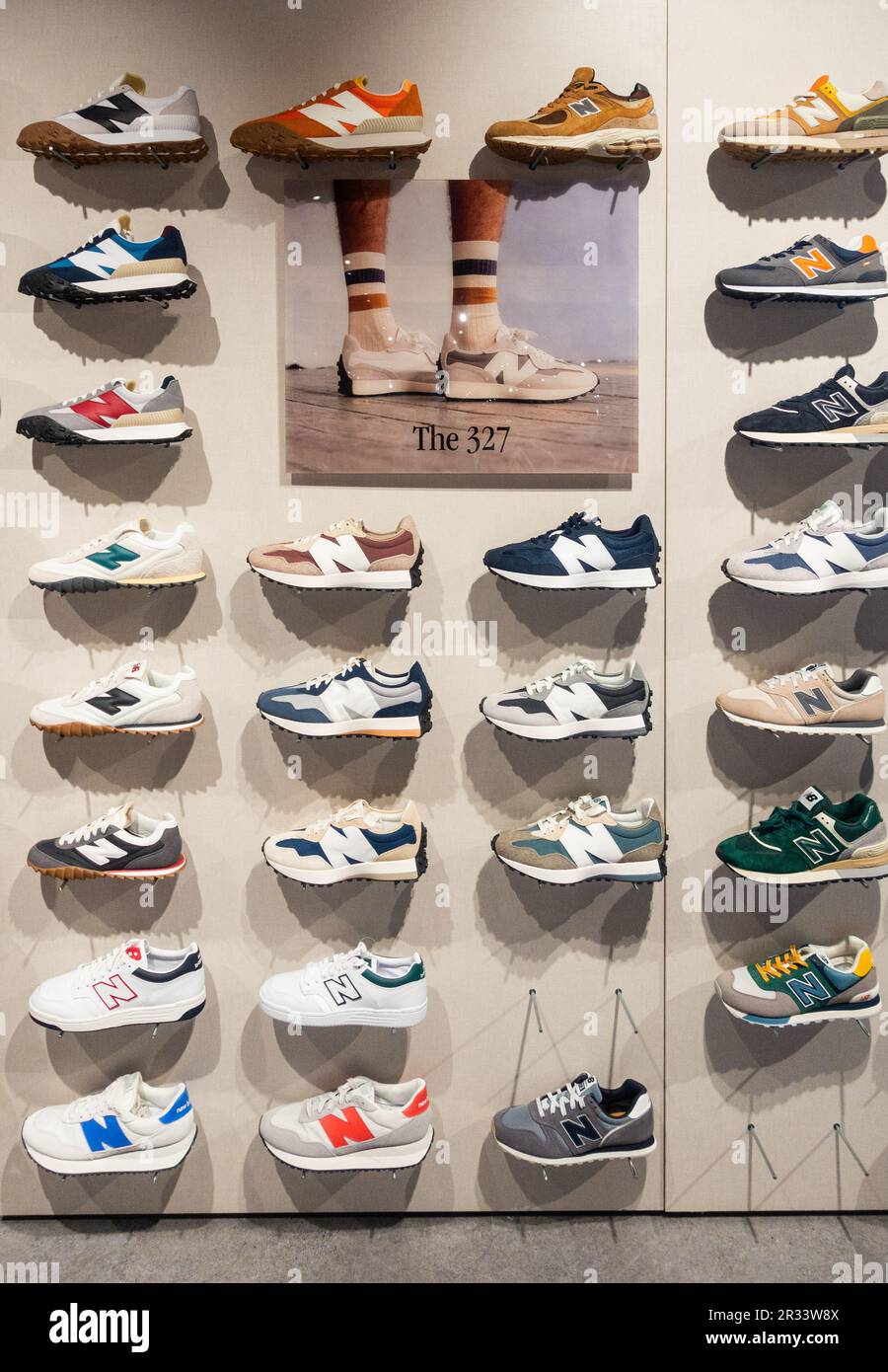 New Balance 327 trainers, training shoes, casual wear footwear display in sports store. Stock Photo
