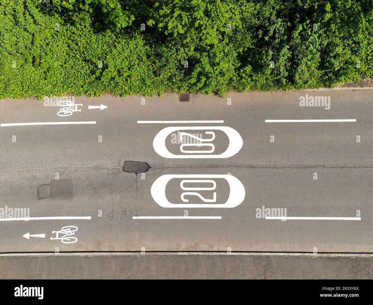 Aerial view of road markings for a 20 mph speed limit zone and cycle lanes. No people. Stock Photo