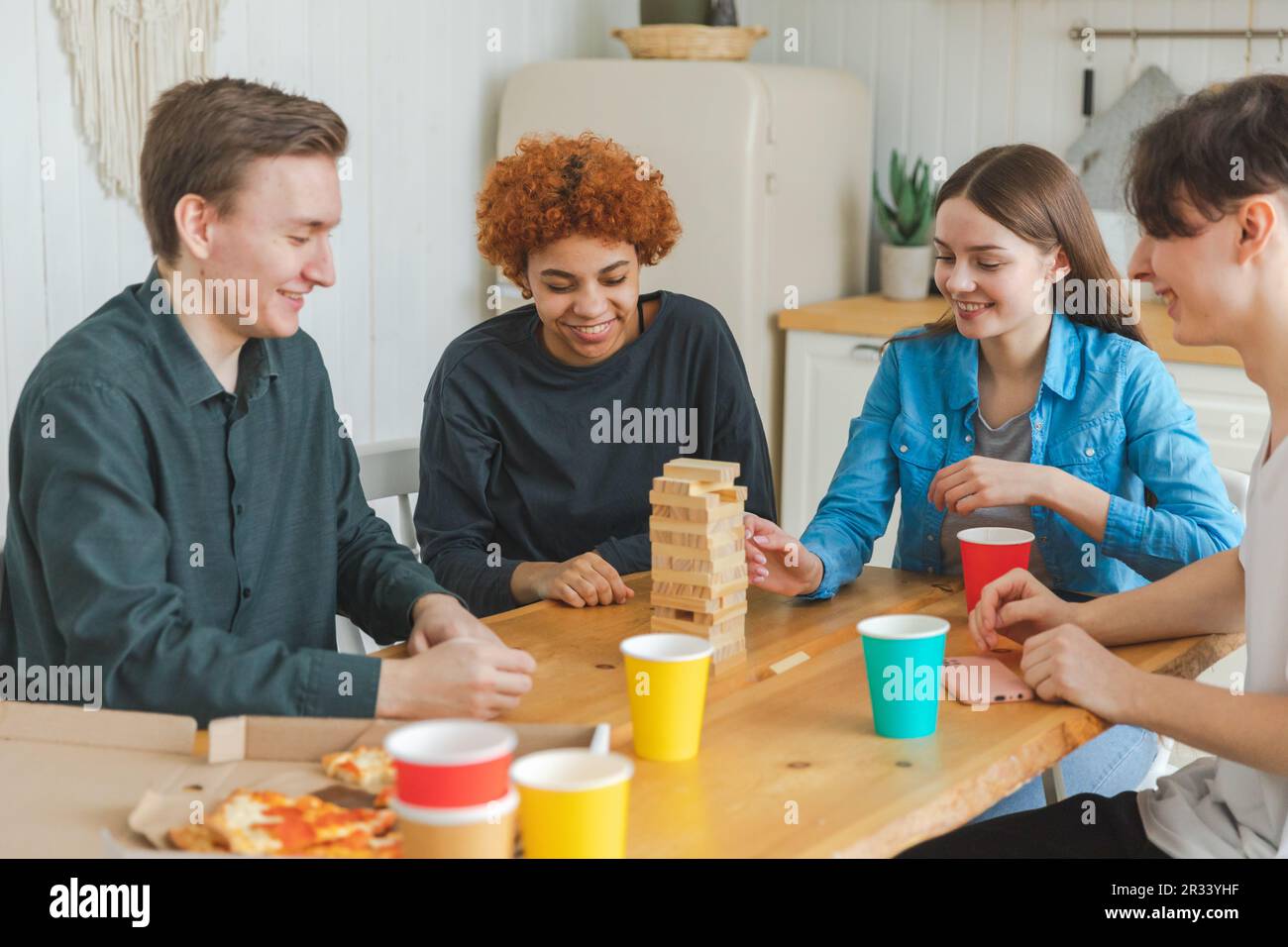 Home party. Friends spending time together playing in board game crash