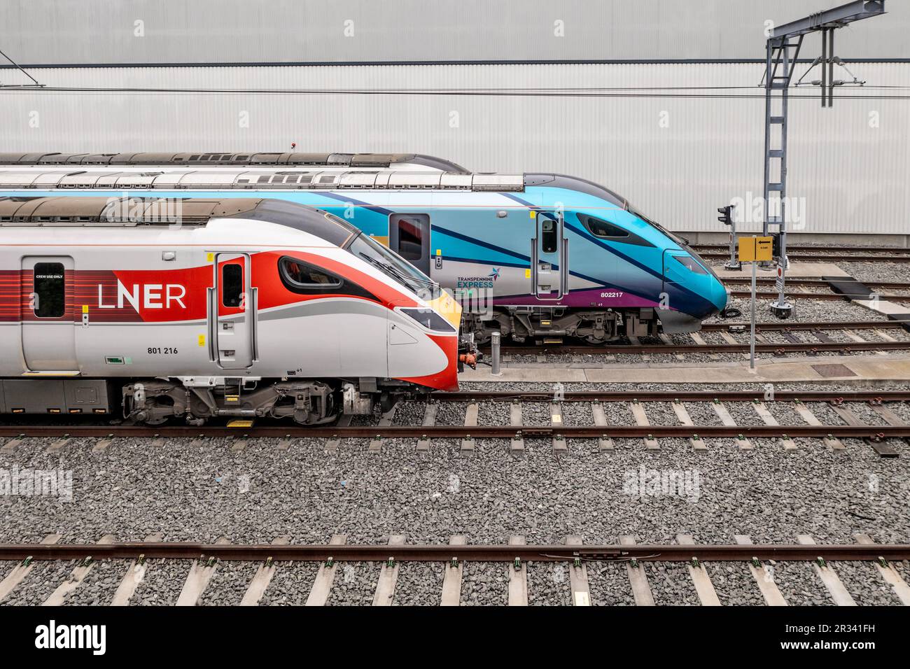 DONCASTER, UK - MAY 13, 2023.  A profile view of a fleet of Hitachi high speed passenger trains in Trans Pennine Express and LNER livery on the Hitach Stock Photo