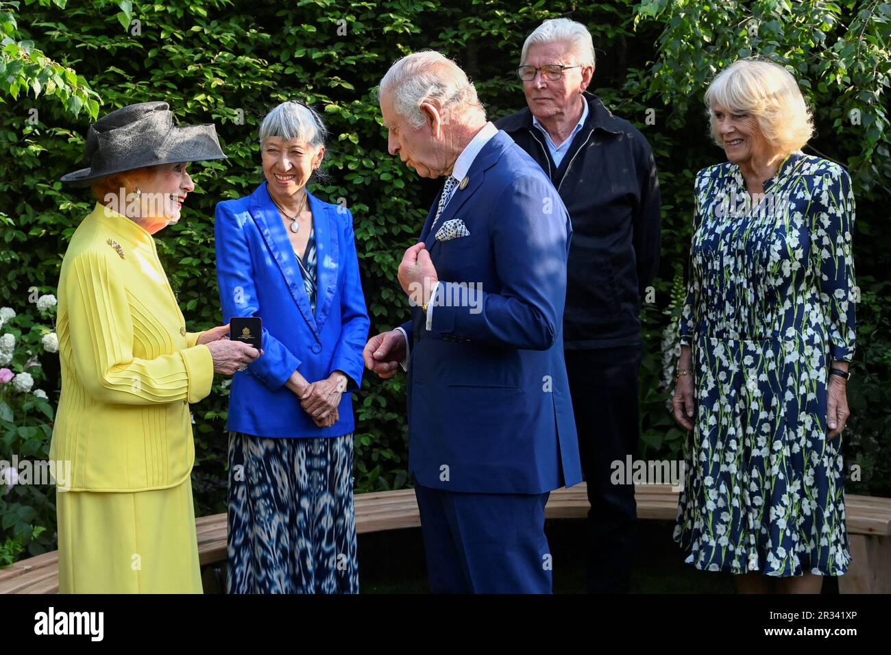 King Charles III and Queen Camilla speak with Janet Fookes (left), Piet Oudolf and Judy Ling Wong after awarding them with the Elizabeth Medal of Honour Award in the Royal Horticultural Society (RHS) Garden of Royal Reflection and Celebration during a visit to the RHS Chelsea Flower, at the Royal Hospital Chelsea, London. Picture date: Monday May 22, 2023. Stock Photo