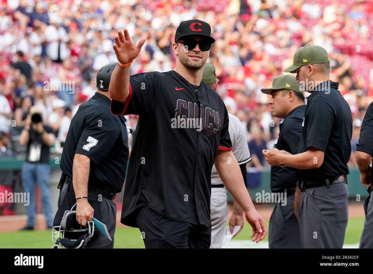 Cincinnati Bengals' Sam Hubbard waves prior to a baseball game between