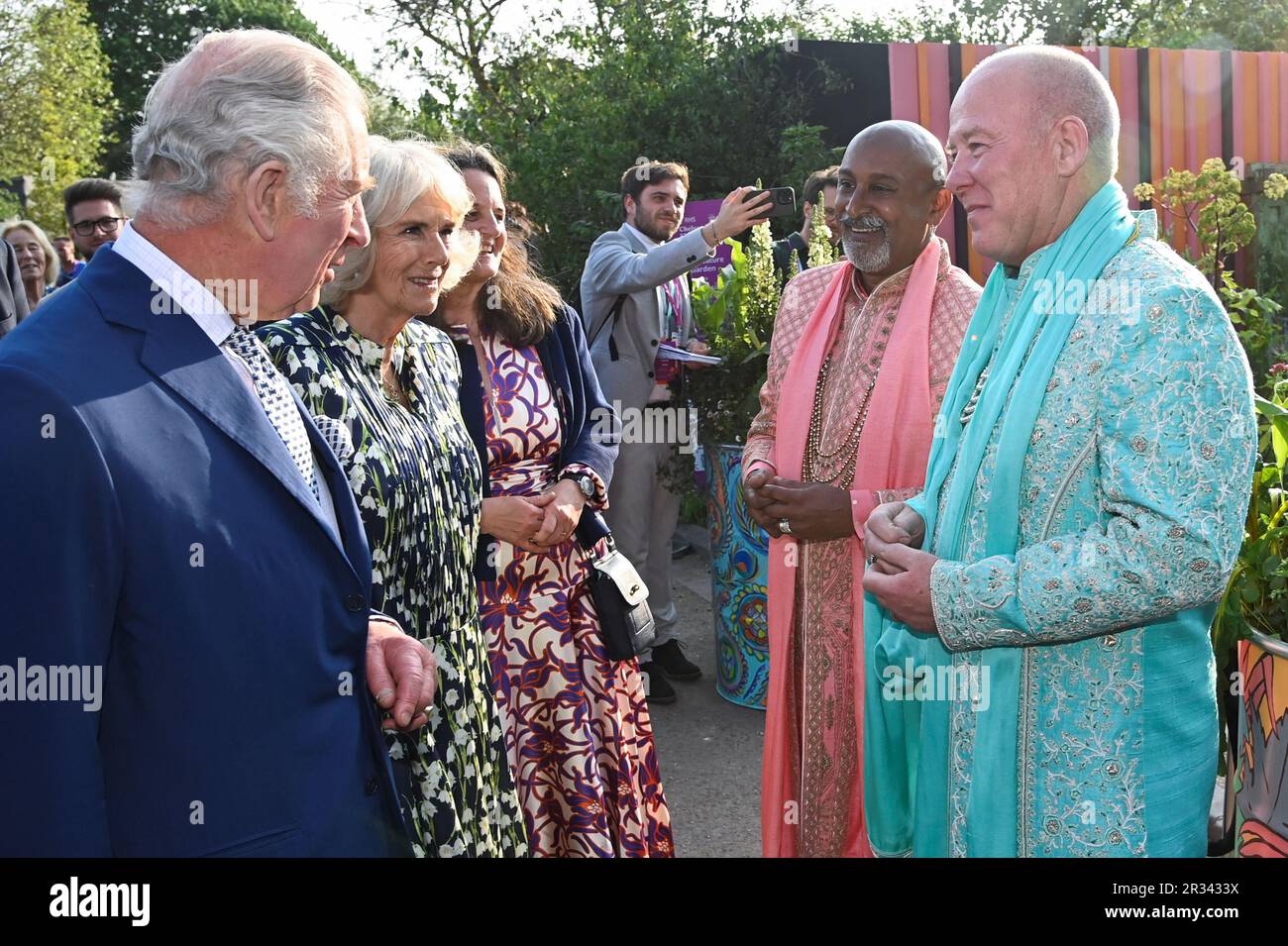 King Charles III and Queen Camilla speak with speak with Manoj Malde, an ambassador for inclusivity, and Clive Gillmor following their traditional Hindu ceremony marriage in the Eastern Eye Garden of Unity during the RHS Chelsea Flower, at the Royal Hospital Chelsea, London. Picture date: Monday May 22, 2023. Stock Photo