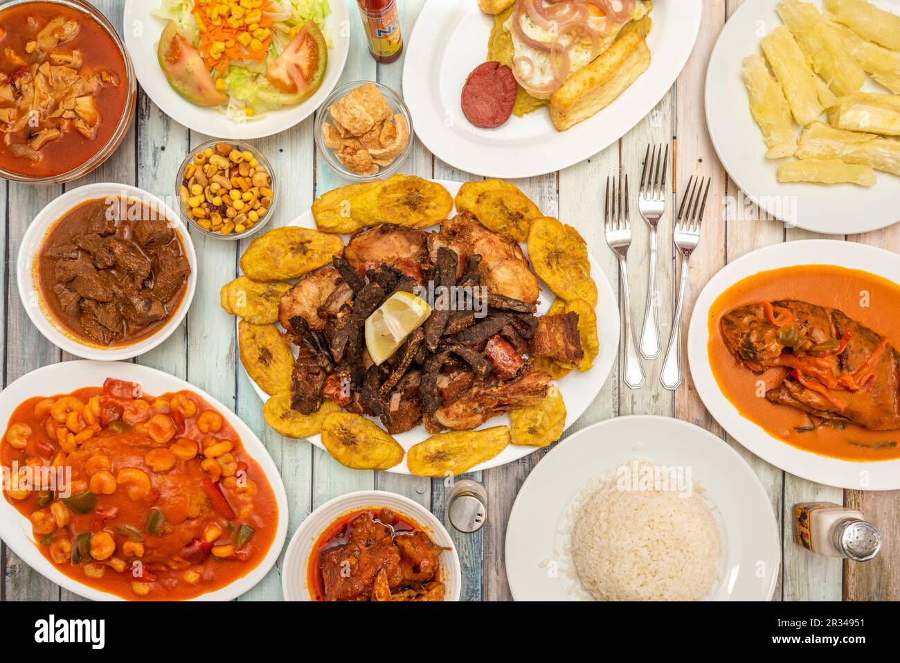 Still life of typical dishes from the Dominican Republic, mofongo with prawns, picatodo, encocado fish, fried cassava and moro rice Stock Photo