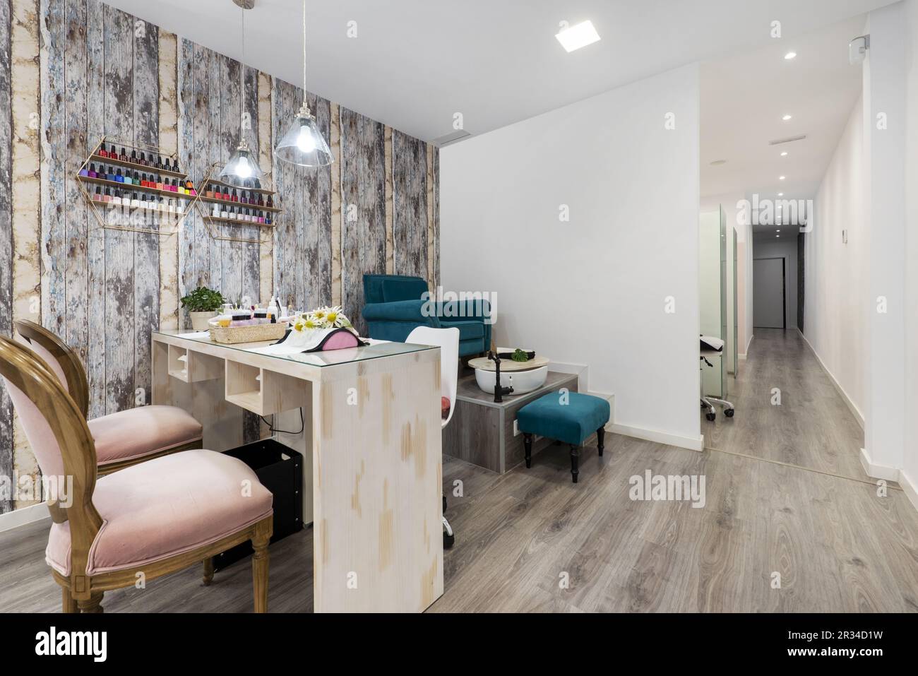 A beauty salon with booths to groom the clients' nails and a long corridor with cabins with stretchers Stock Photo