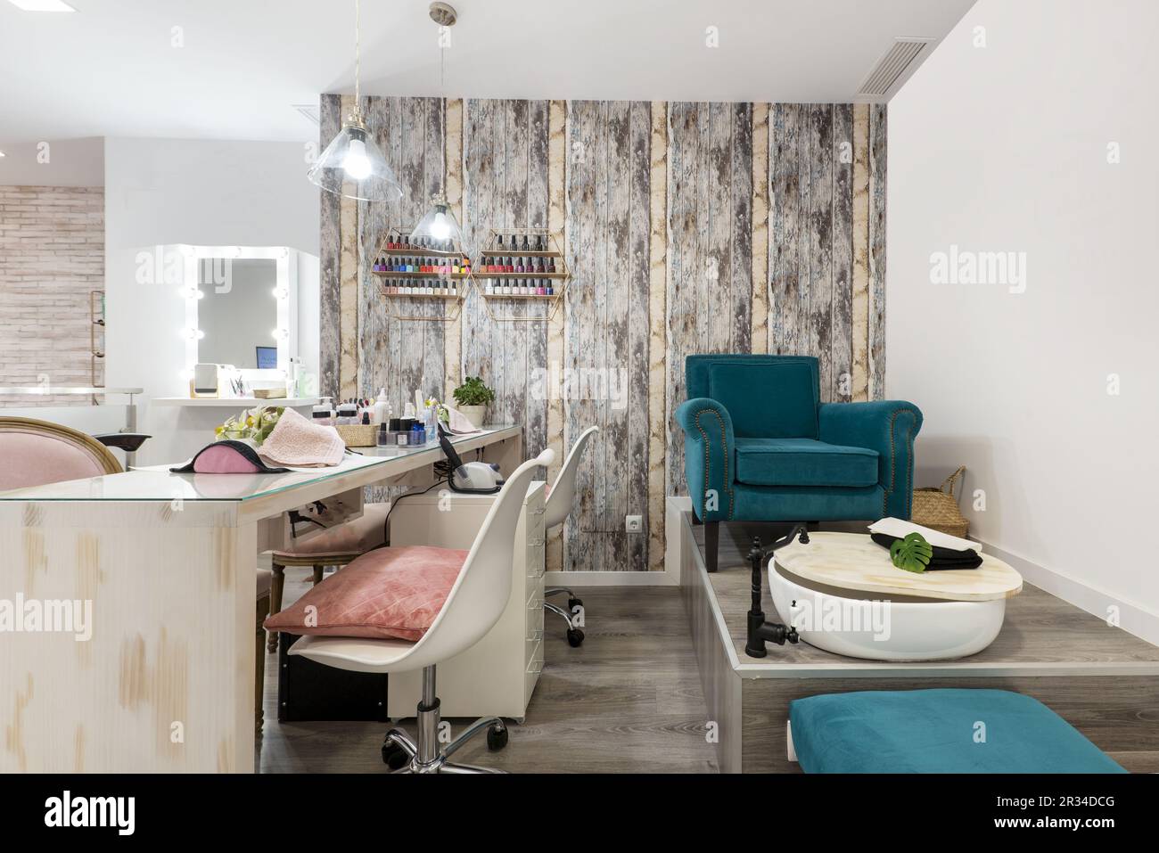 A beauty salon with stalls with chairs to fix clients' nails and an armchair to do pedicures Stock Photo