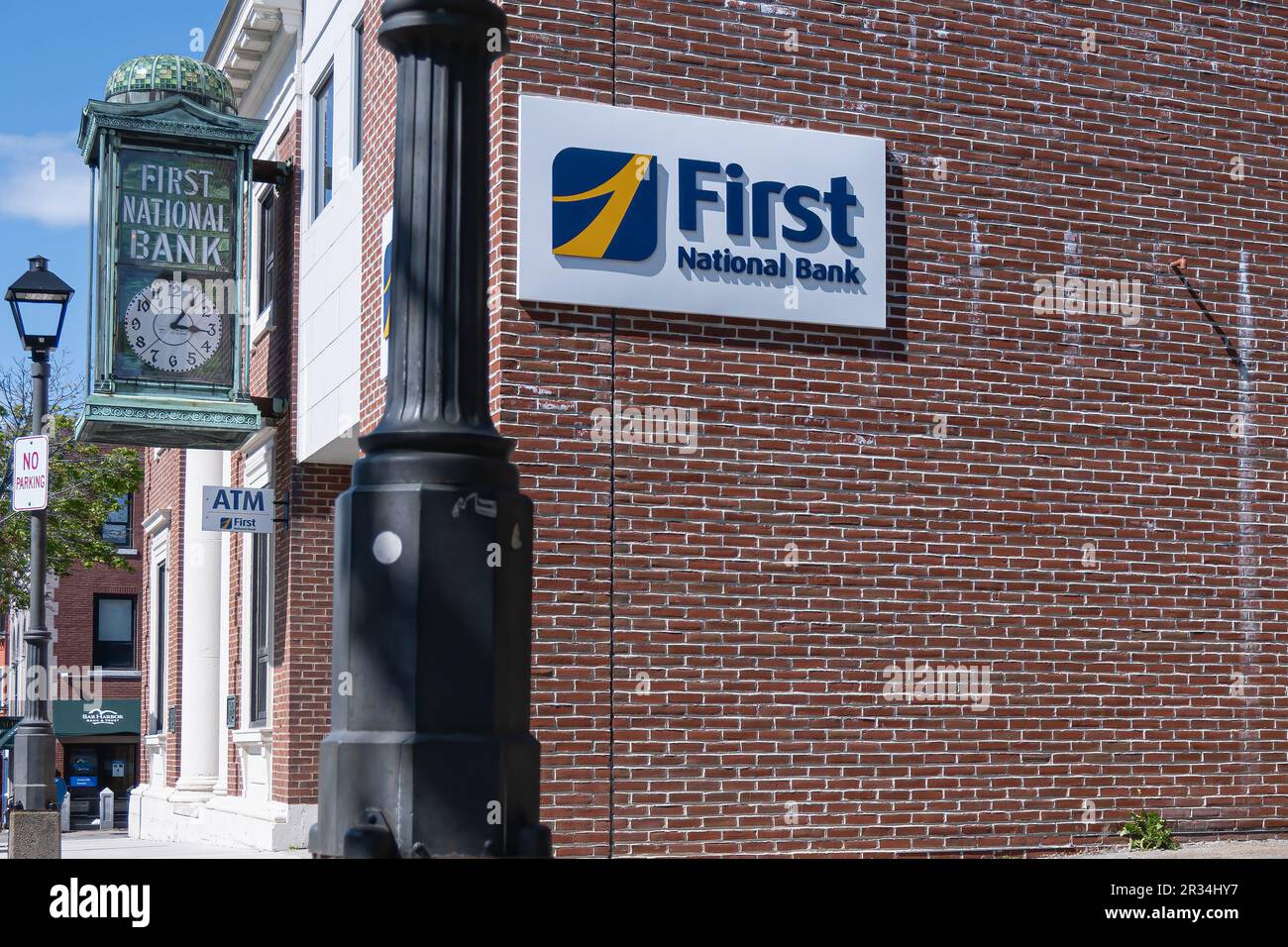 First National Bank sign and ornate clock in Bar Harbor, Maine, USA. Stock Photo