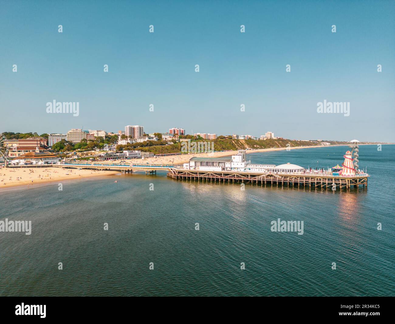 Bournemouth, UK. 22nd May, 2023. Golden hour sun on Bournemouth Pier with a busy beach. Credit: Thomas Faull/Alamy Live News Stock Photo