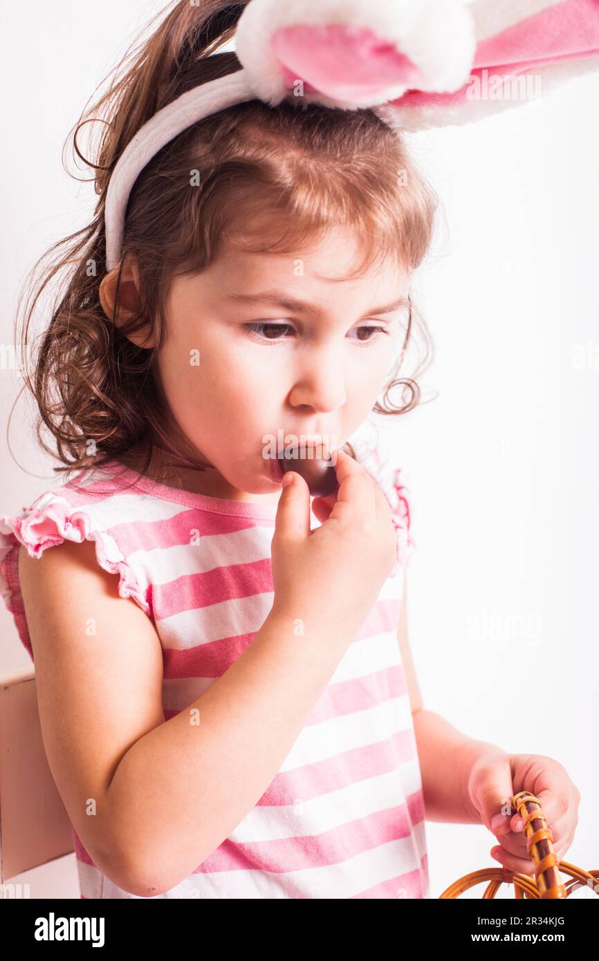 Girl eats a chocolate eggs Stock Photo - Alamy