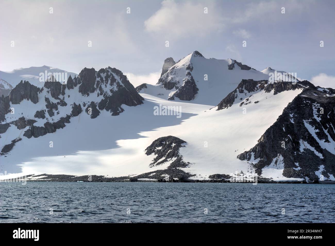 Snow-capped mountains and rocks of Antarctica Stock Photo