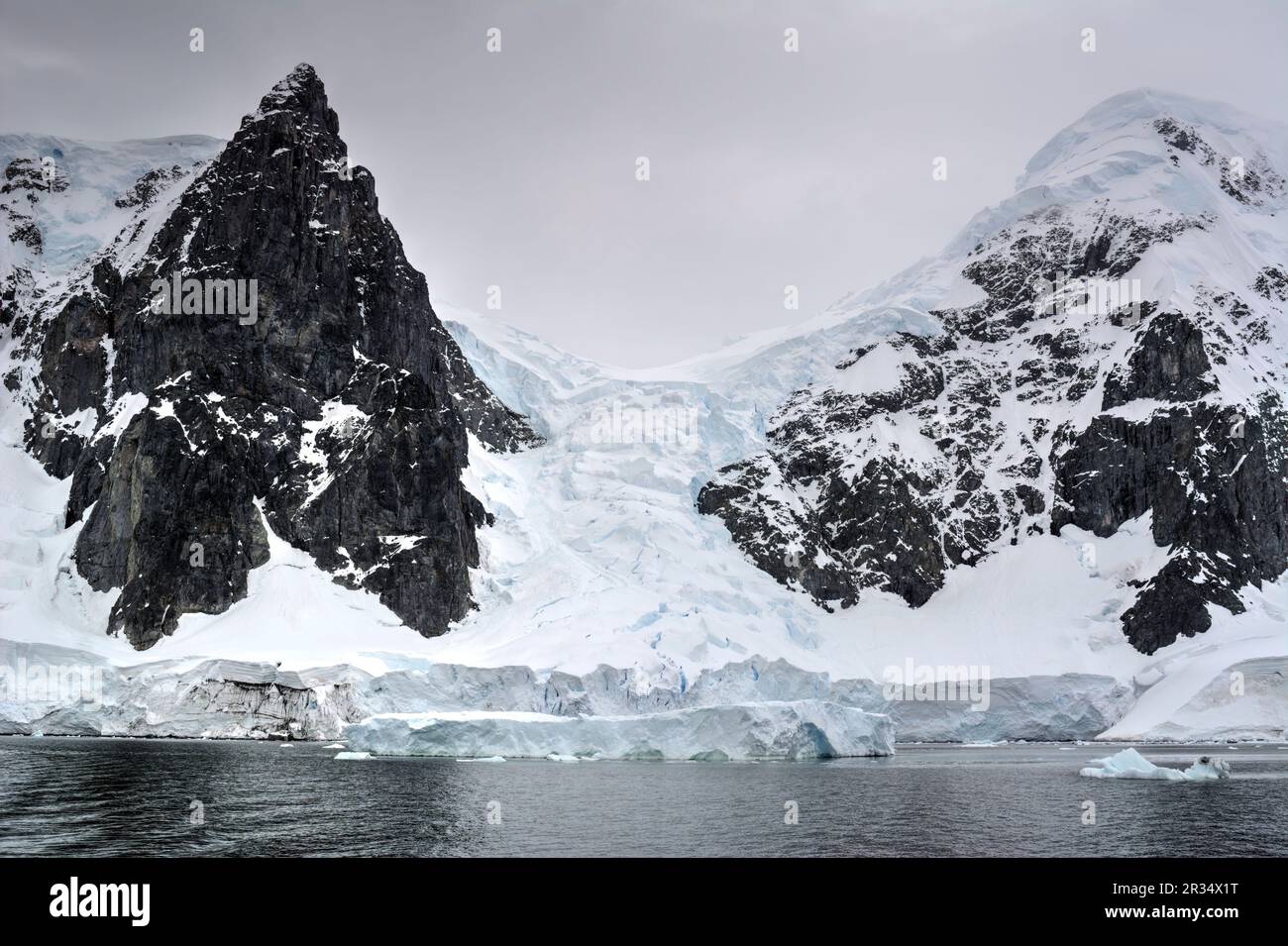 Snow-capped mountains and rocks of Antarctica Stock Photo