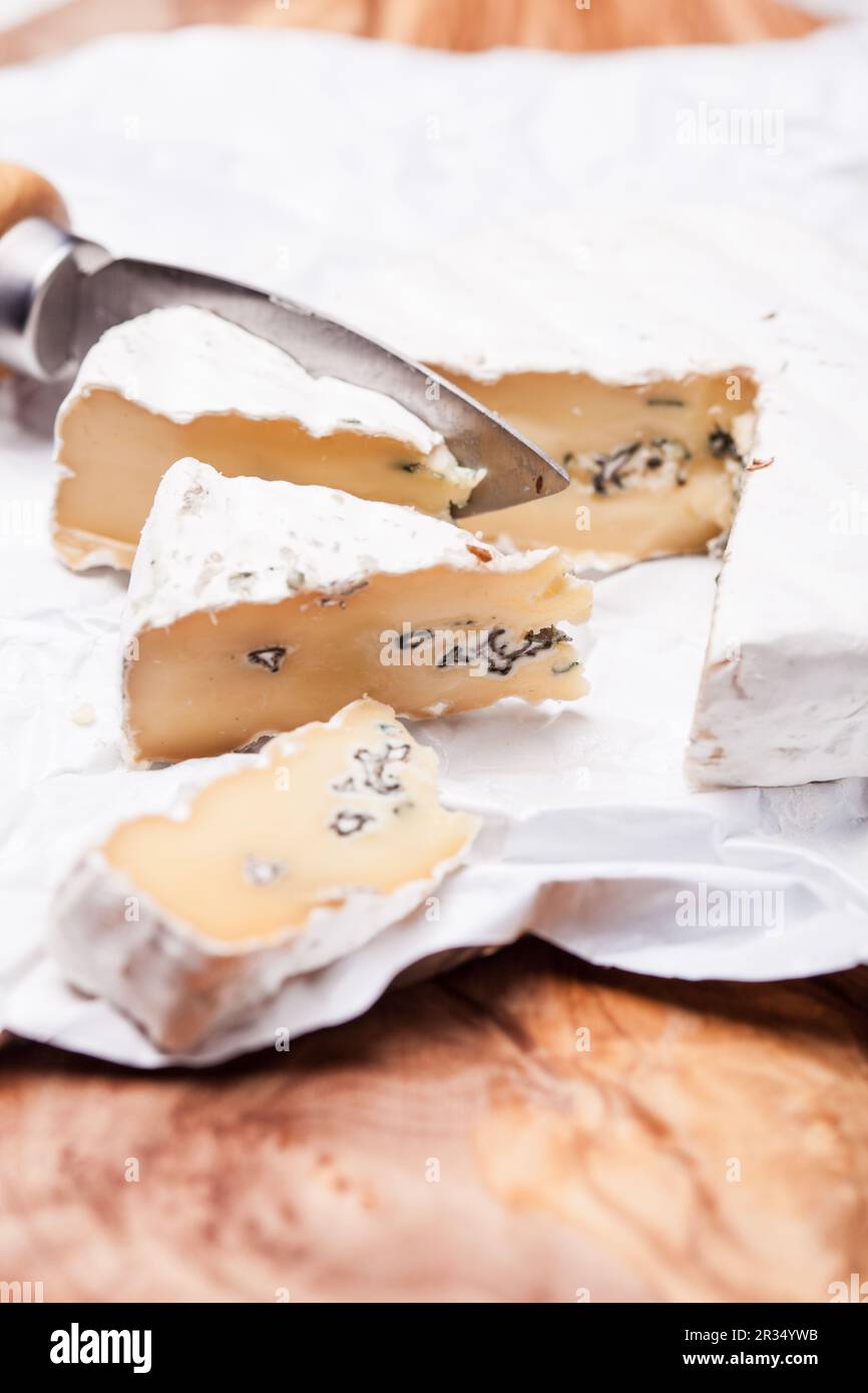 Soft cheese containing veins of blue mold and a firm white skin. Two