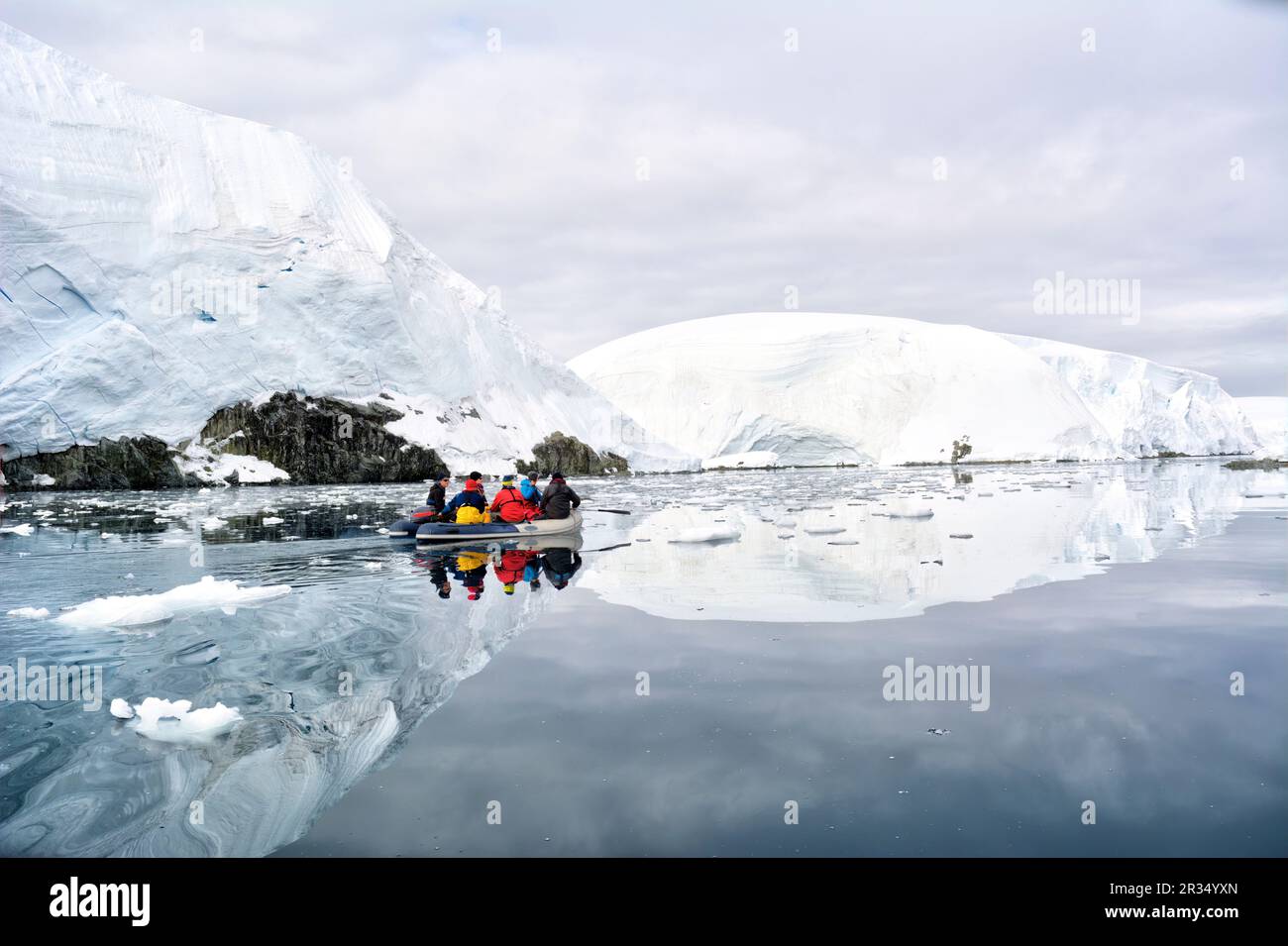 A group of tourists makes an excursion on a motorboat in Antarctica. Stock Photo