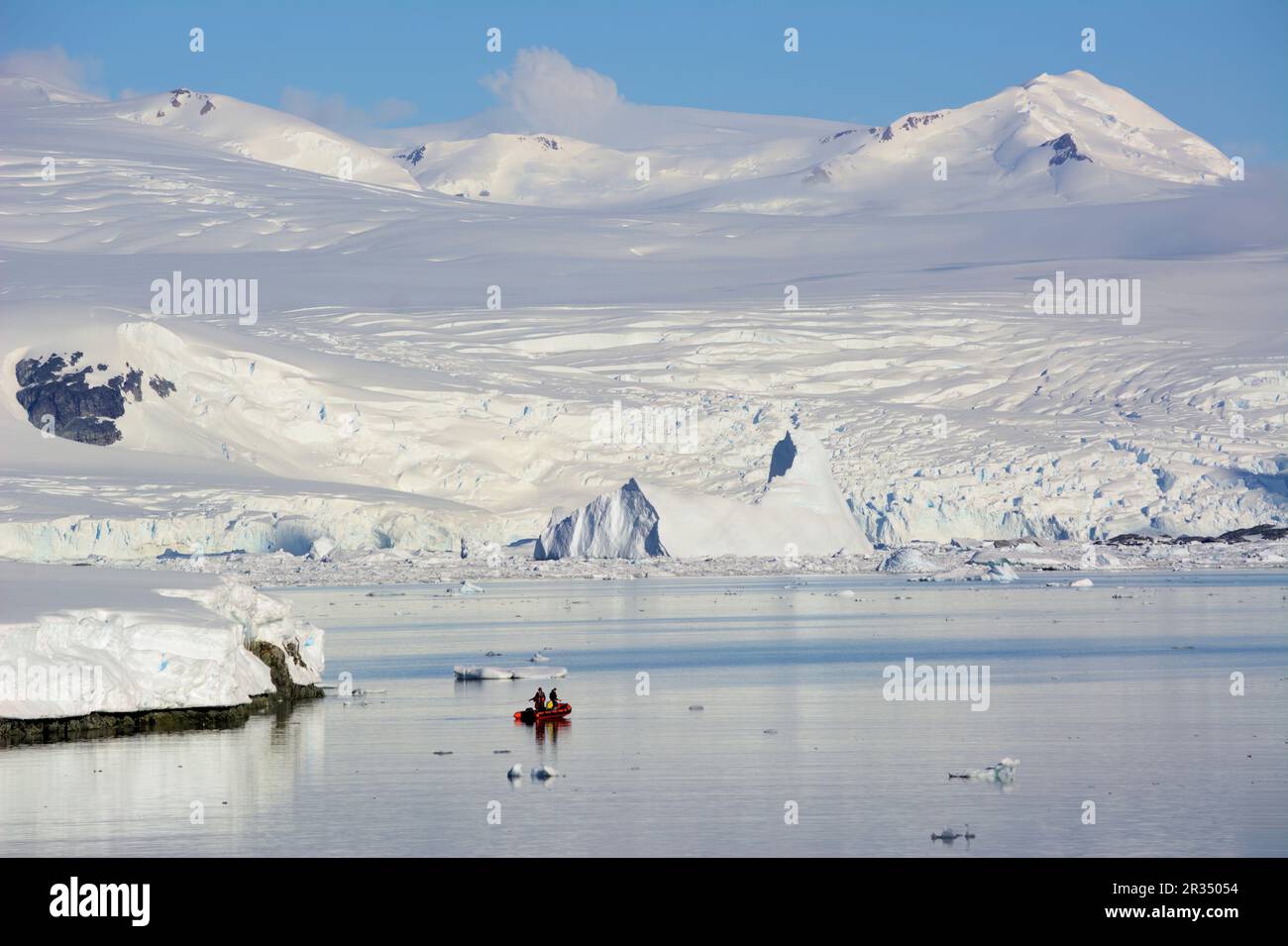 A group of tourists makes an excursion on a motorboat in Antarctica. Stock Photo