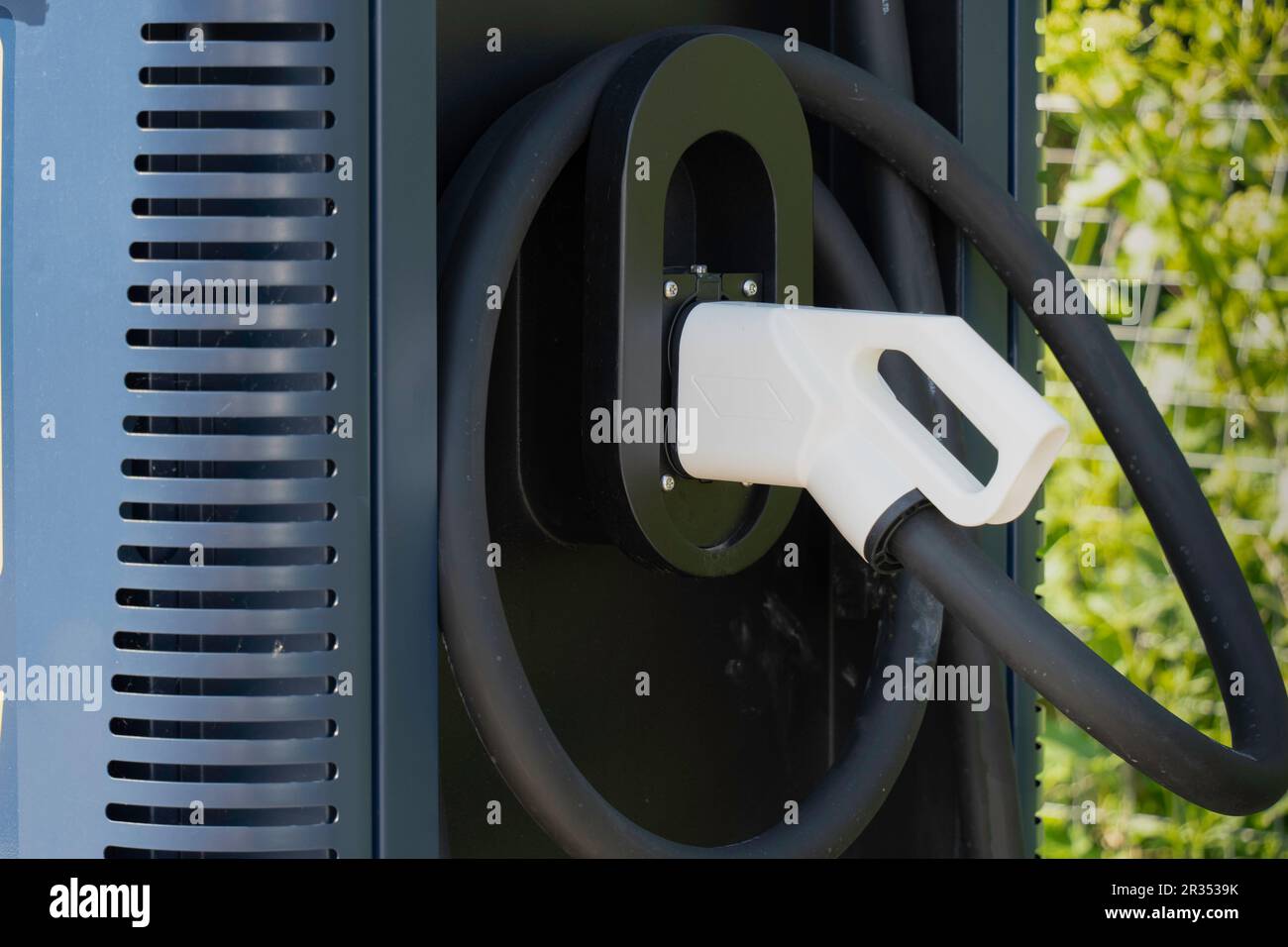 Connector at electric car charging station (EV charging) Stock Photo