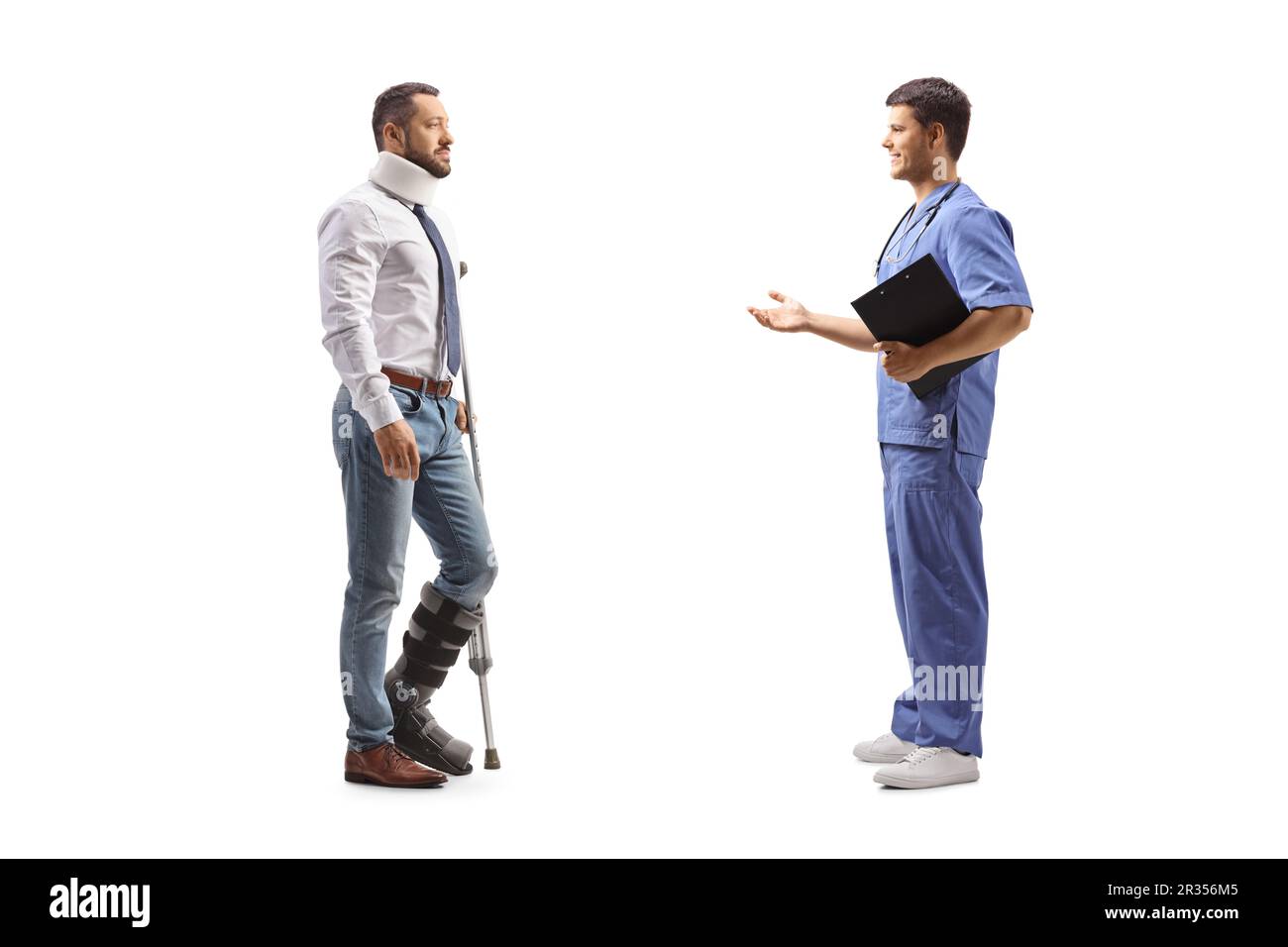 Full length profile shot of an injured man with a walking brace and cervical collar listening to a healthcare worker isolated on white background Stock Photo