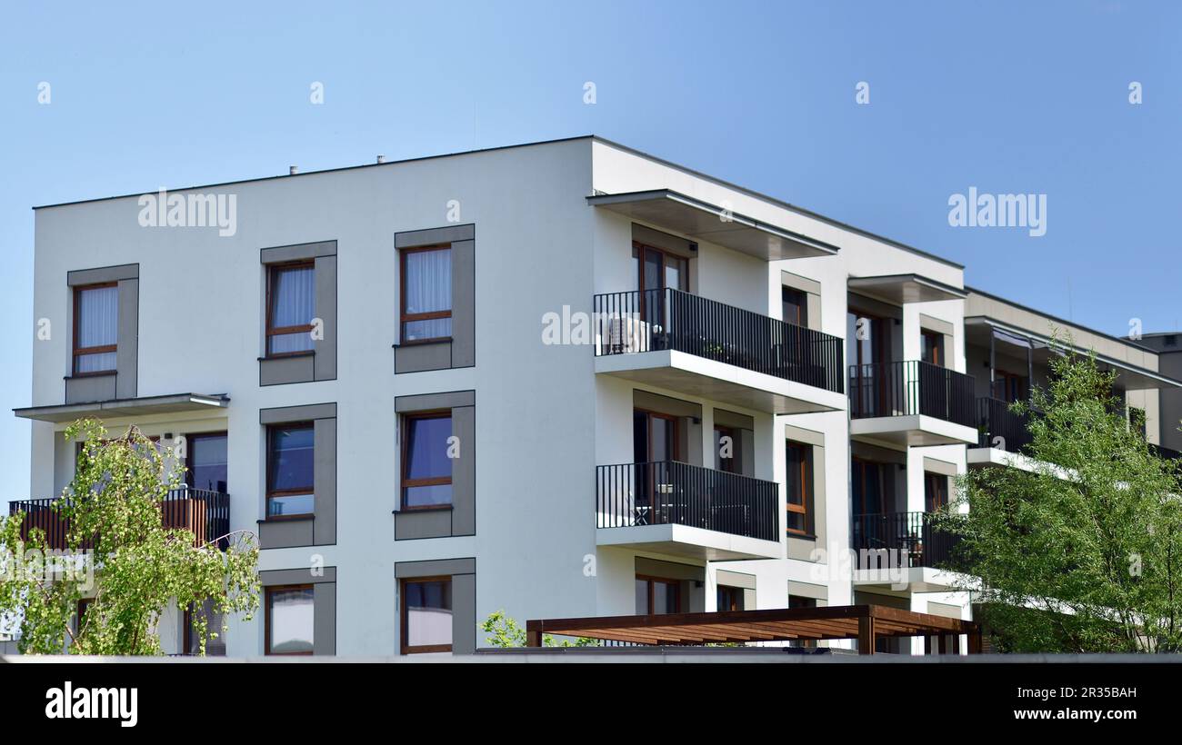 Eco architecture. Green tree and new apartment building. The harmony of