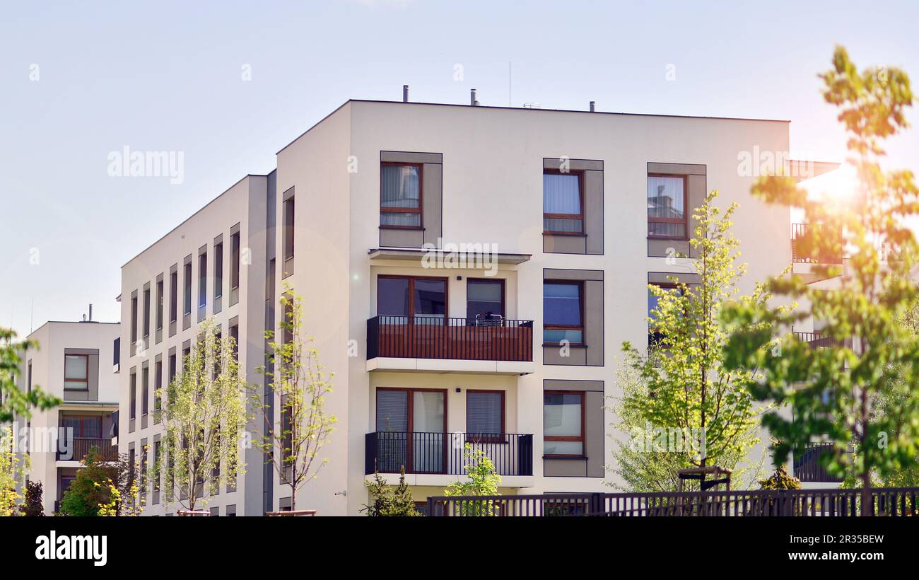 Eco architecture. Green tree and new apartment building. The harmony of ...