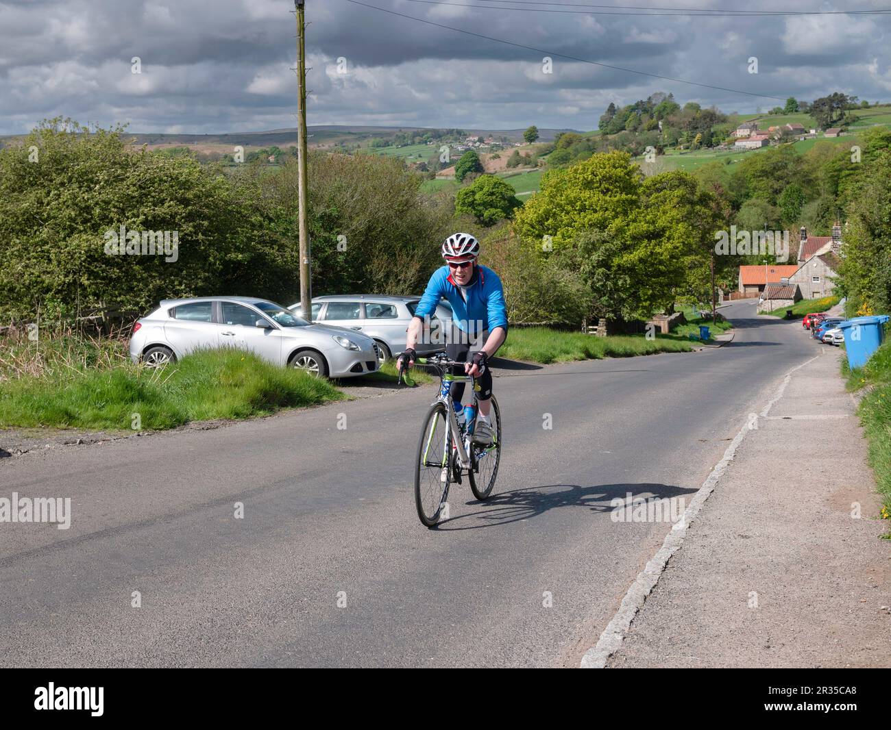 Sporting Cyclist climbing a hill out of Danby in thw North |Yorkshire Moors Stock Photo