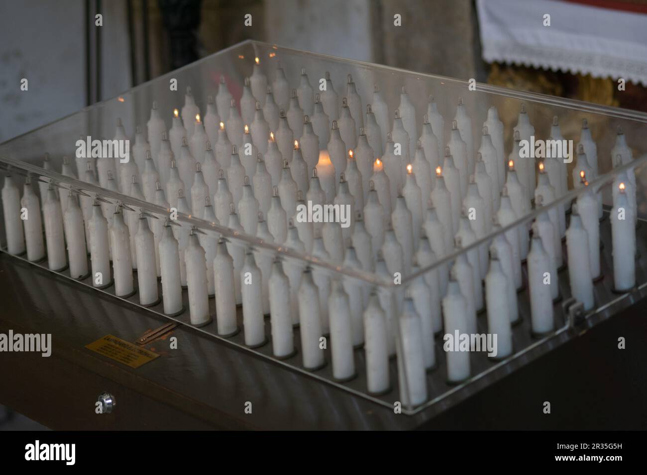 Electric candles to pay promises to the saints, they work after inserting a coin Stock Photo