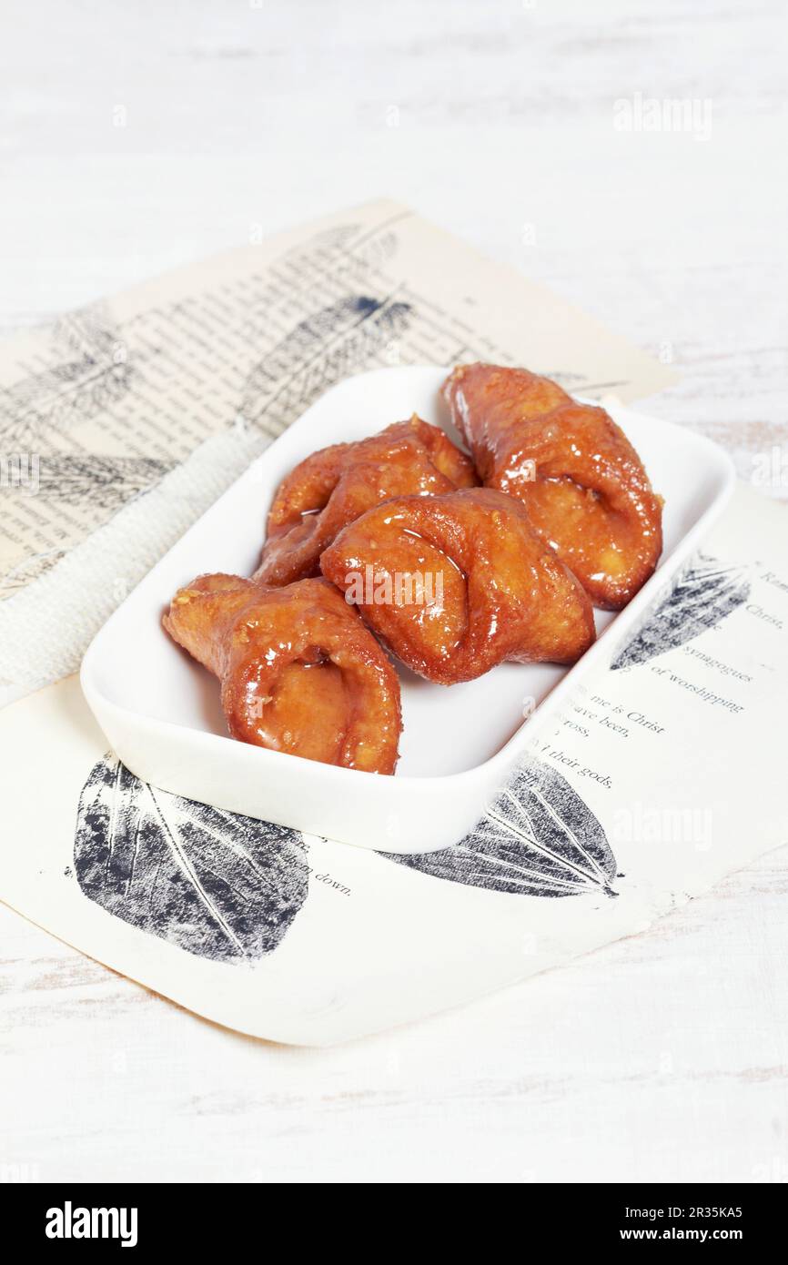 Pestions (deep-fried pastries with honey glaze, Spain Stock Photo - Alamy