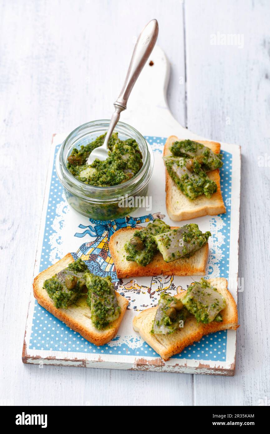 Toast topped with herring in salsa verde Stock Photo
