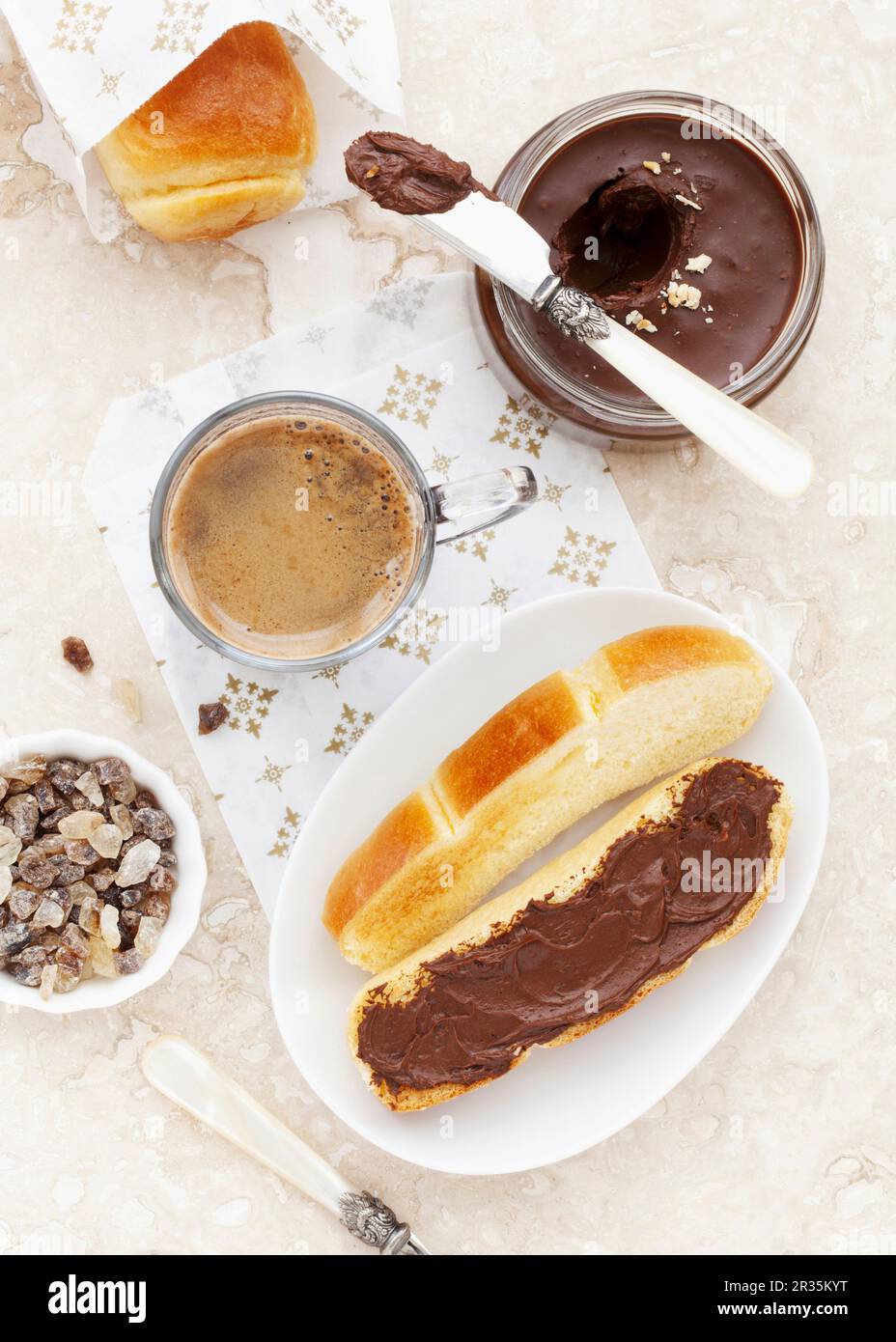 A toasted brioche roll with chocolate spread served with coffee Stock