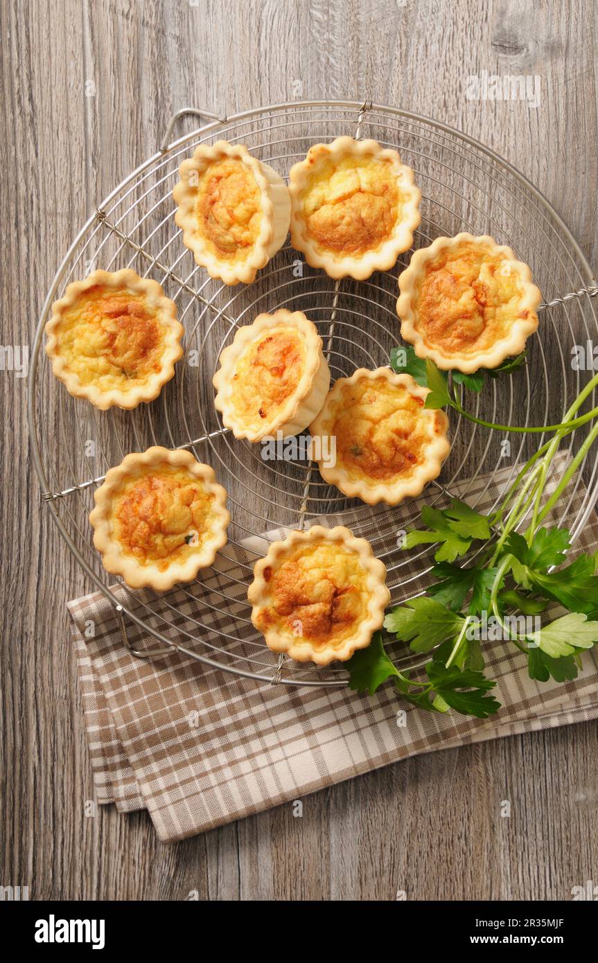 Spicy mini quiche on a cooling rack Stock Photo