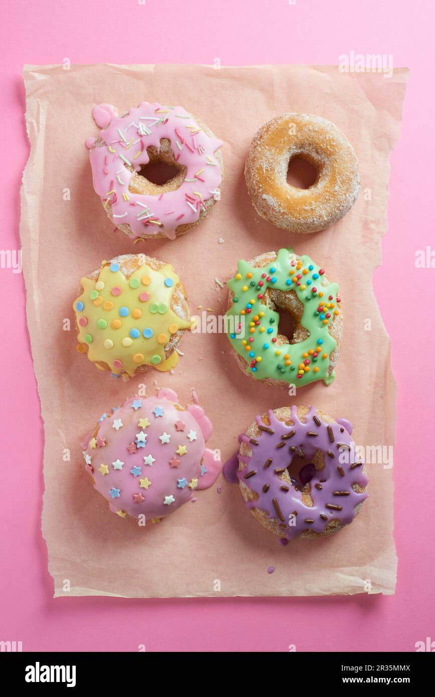 Doughnuts with glaze on a pink surface Stock Photo