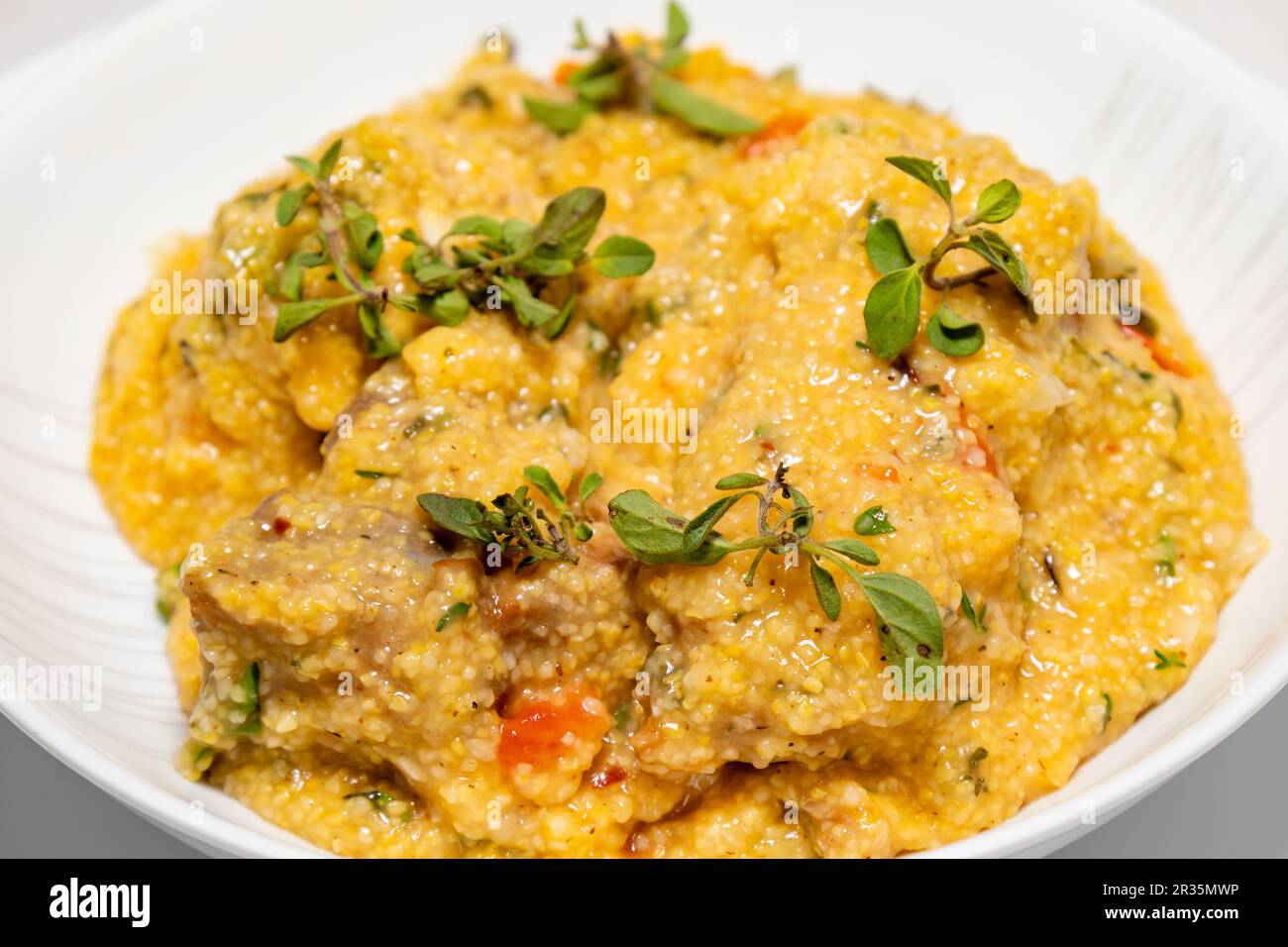 Traditional pork tenderloin recipe with corn grits and fresh marjoram